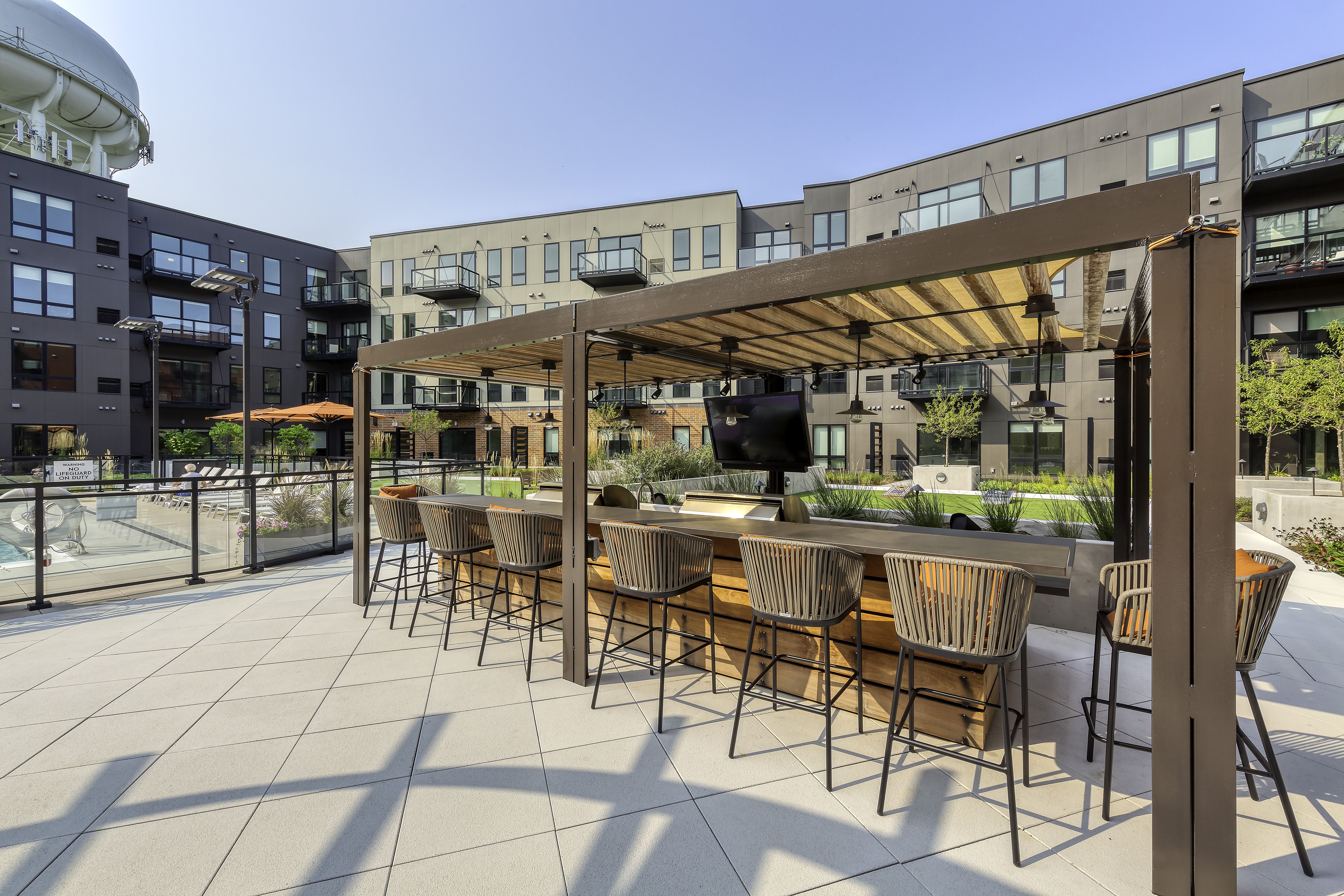 grill and poolside seating area at senior community