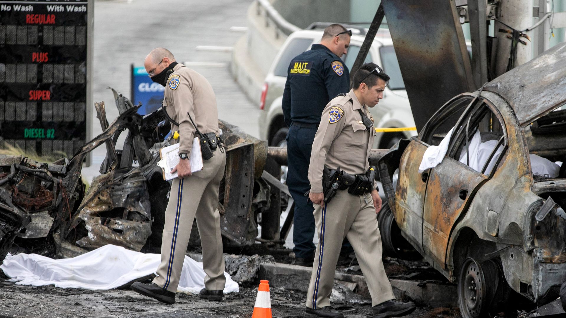 Law enforcement officials investigating a fatal crash at a gas station in Los Angeles on Aug. 4.