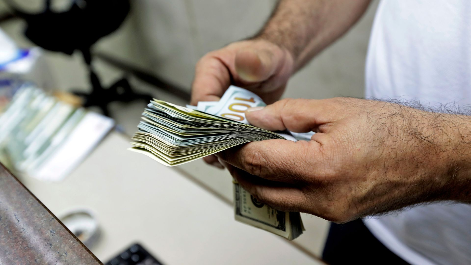 A person holds money as if he is counting it.