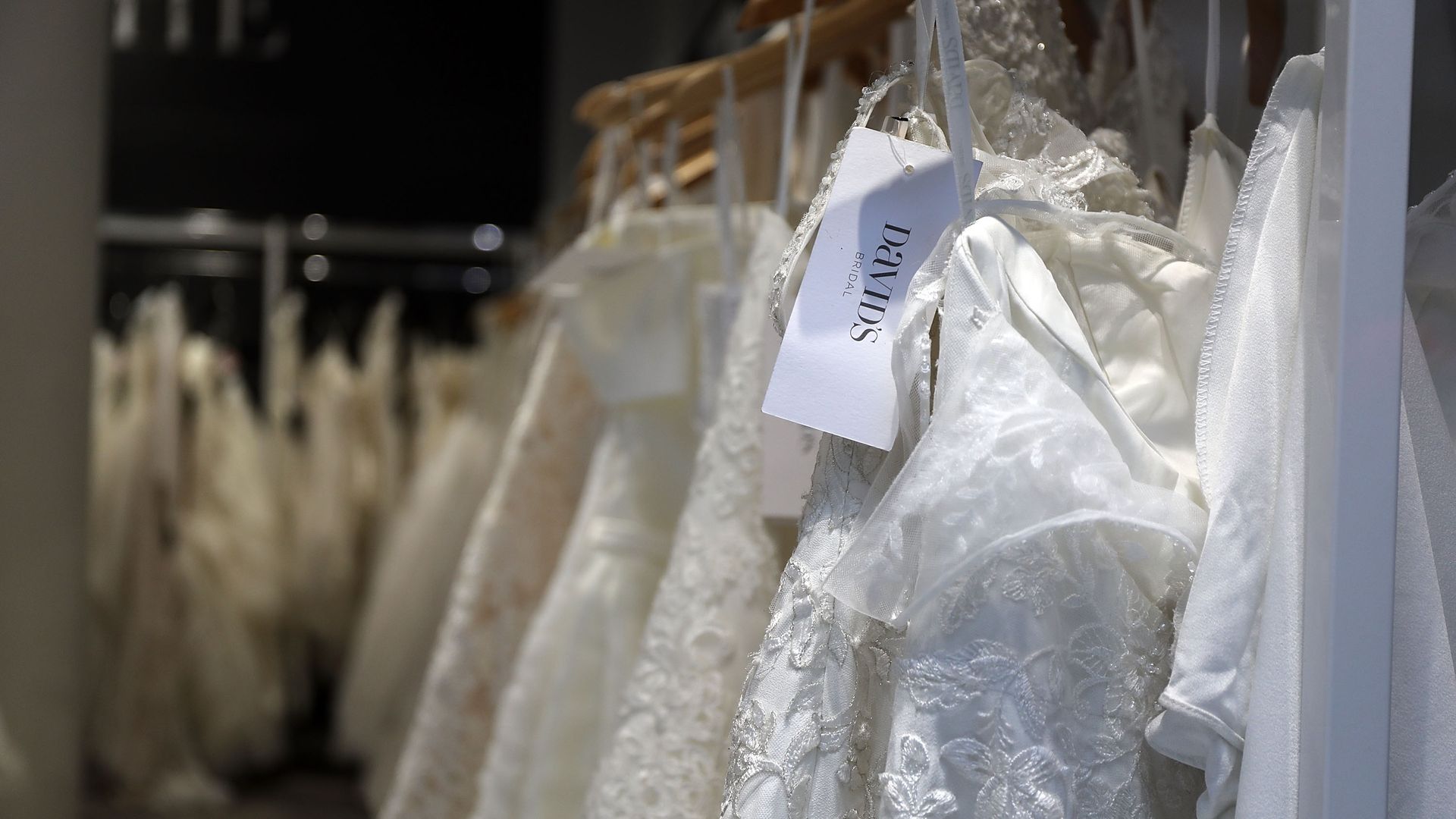 White wedding dresses on racks at a store