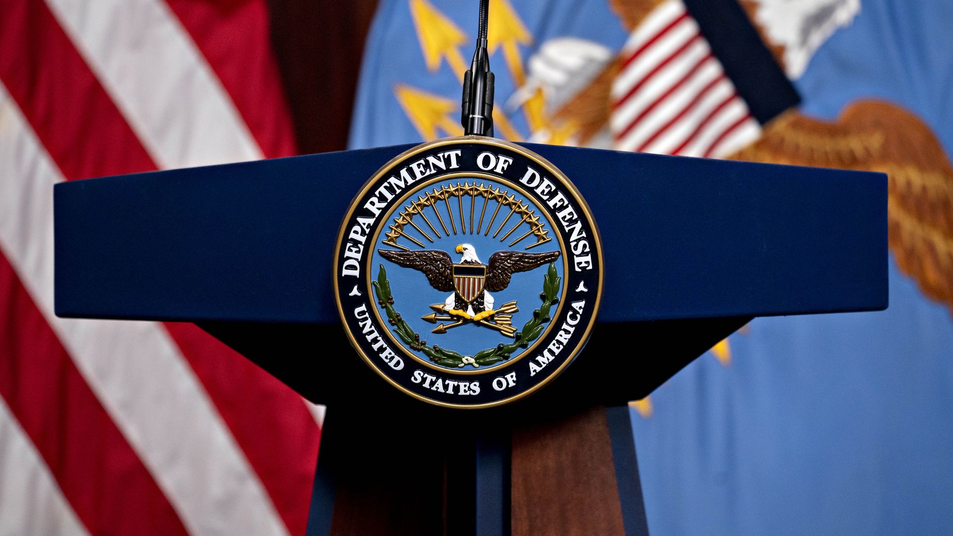 Photo of a lecturn with the Department of Defense seal