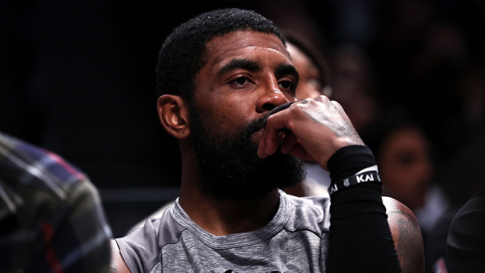 Kyrie Irving #11 of the Brooklyn Nets looks on from the bench.