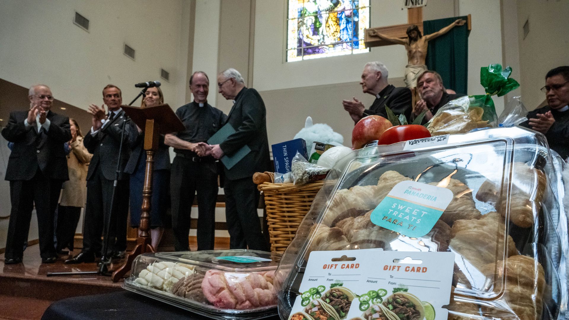 A food basket can be seen as Archbishop José Gomez joins clergy at St. Patrick's Catholic Church in South Los Angeles as they launch a Family Assistance Program in their parishes for those impacted by immigration raids on Wednesday, July 23, 2025. 