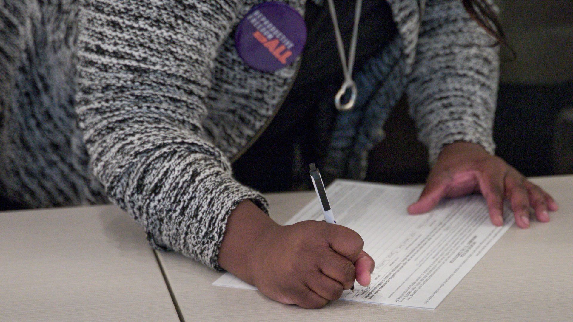A person signs a Reproductive Freedom for All petition.