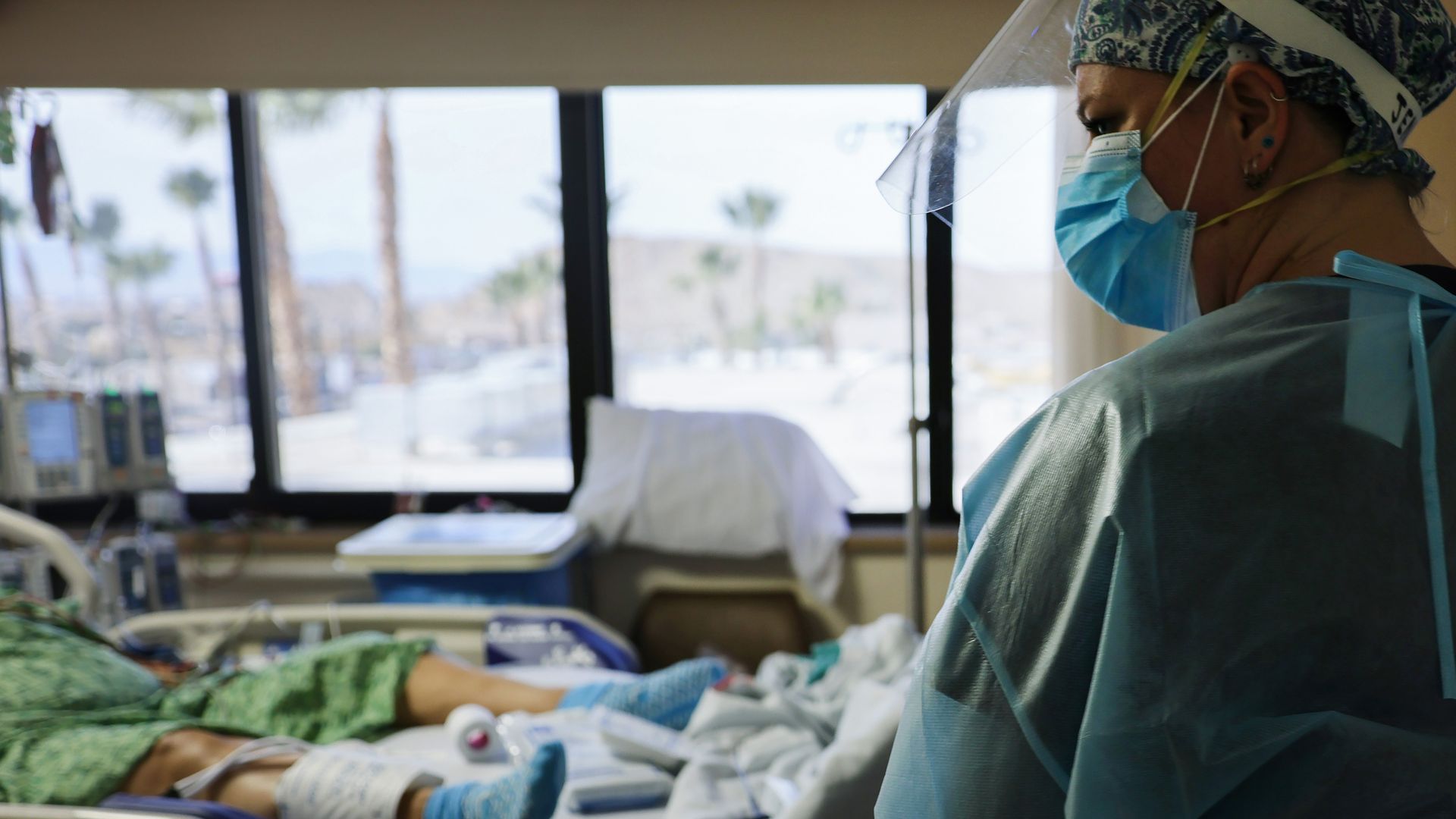 A clinician cares for a COVID-19 patient in the Intensive Care Unit (ICU) at Providence St. Mary Medical Center amid a surge in COVID-19 patients in Southern California on December 23