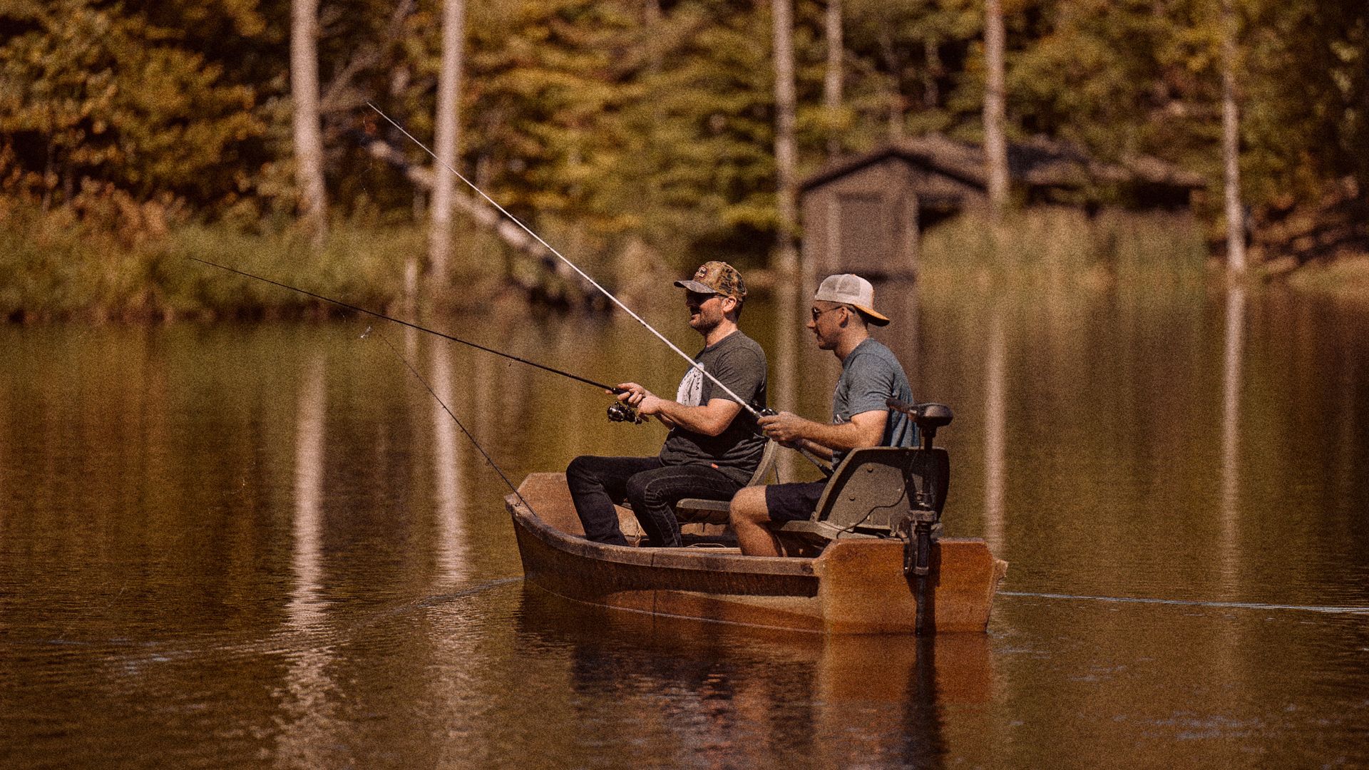 two people fishing in a small boat