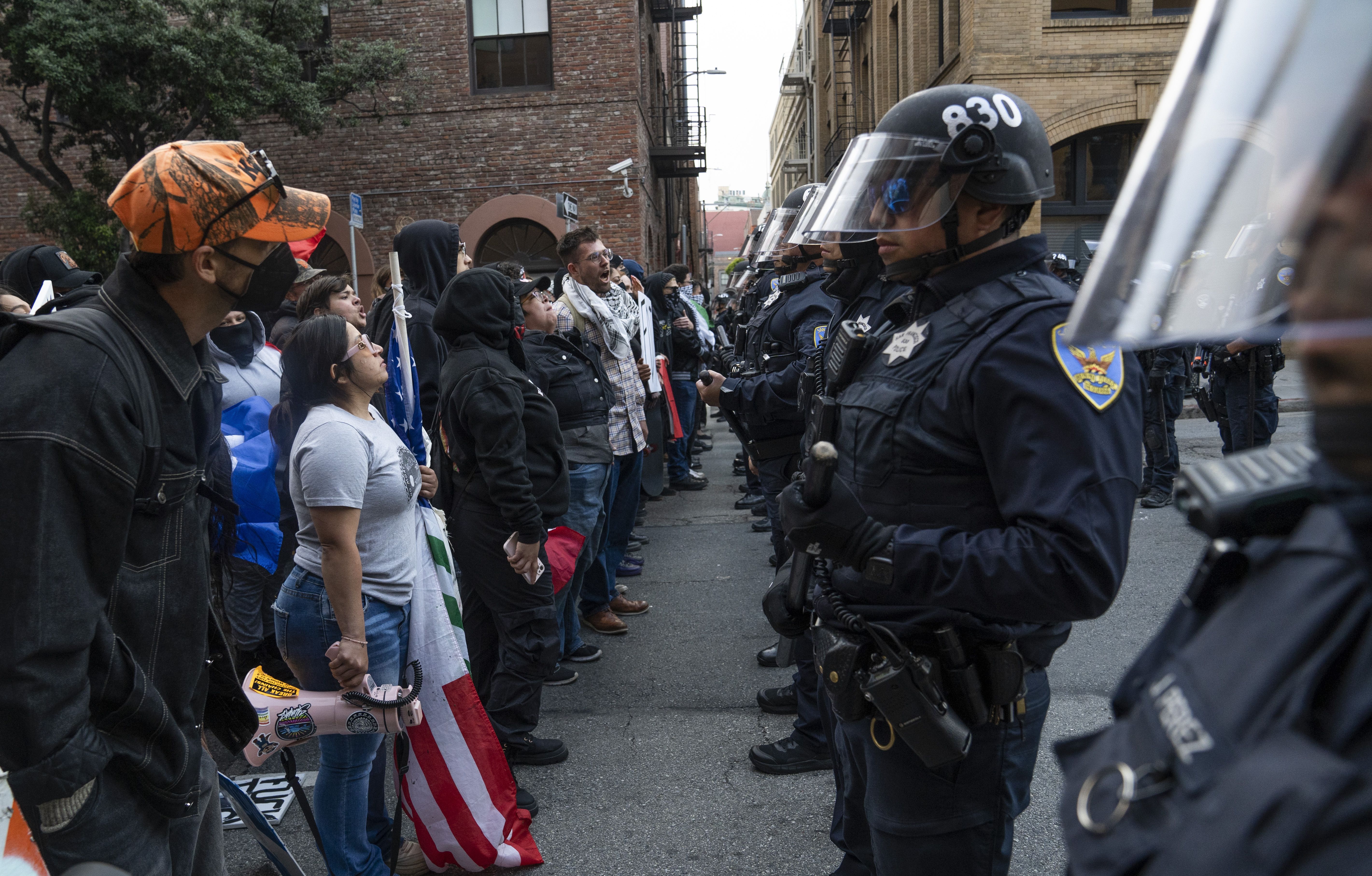 Protesters stare down law enforcement in a San Francisco street.