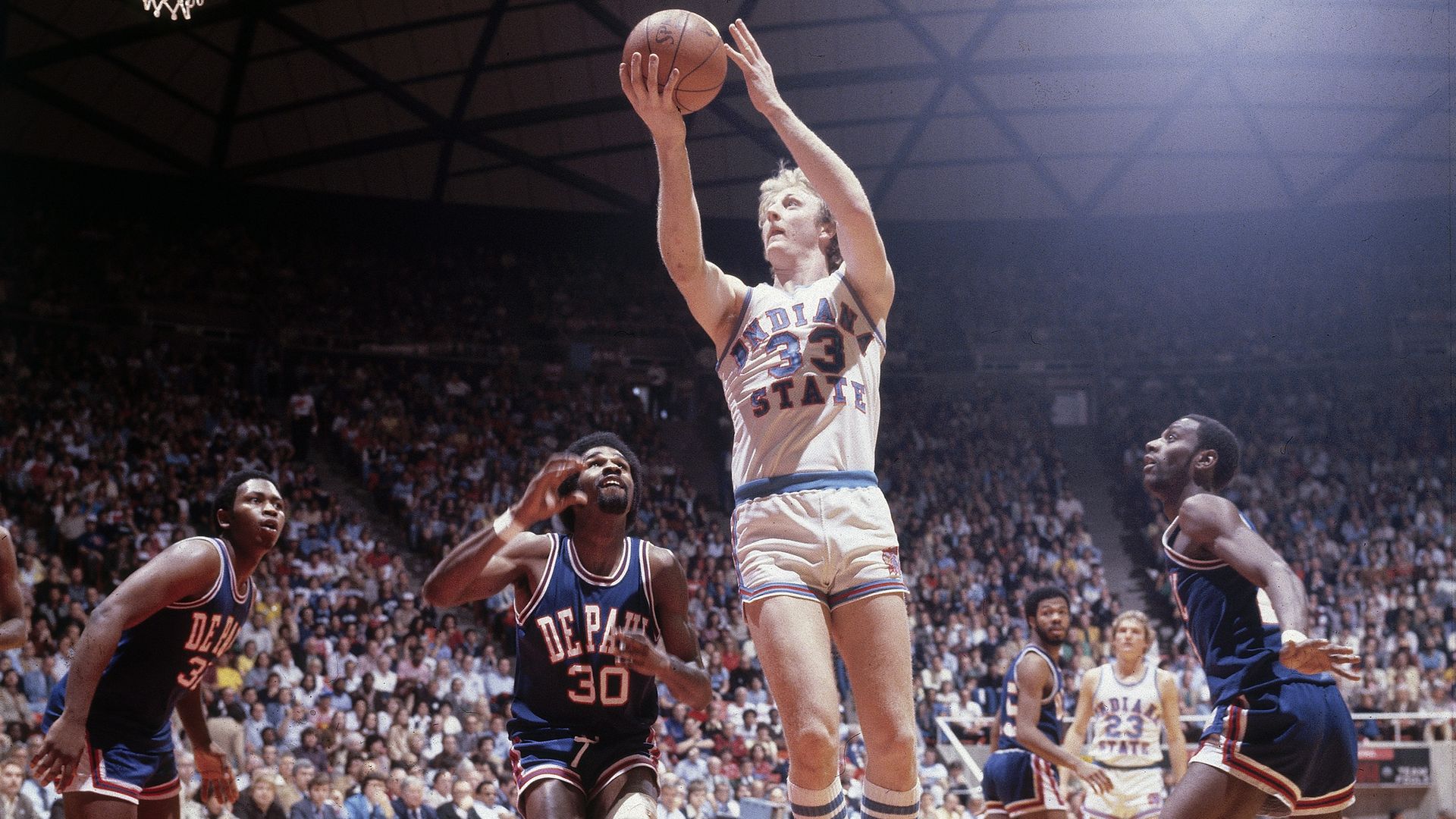 Photo of basketball player shooting a basket. 