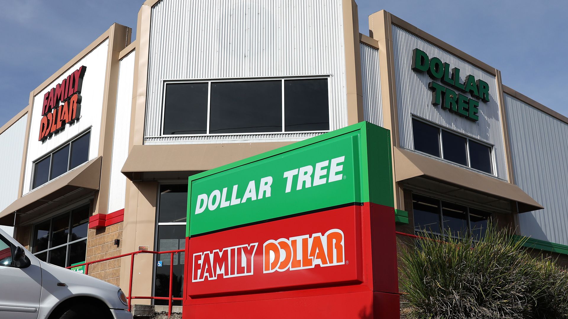 Family Dollar and Dollar Tree stores next to each other.