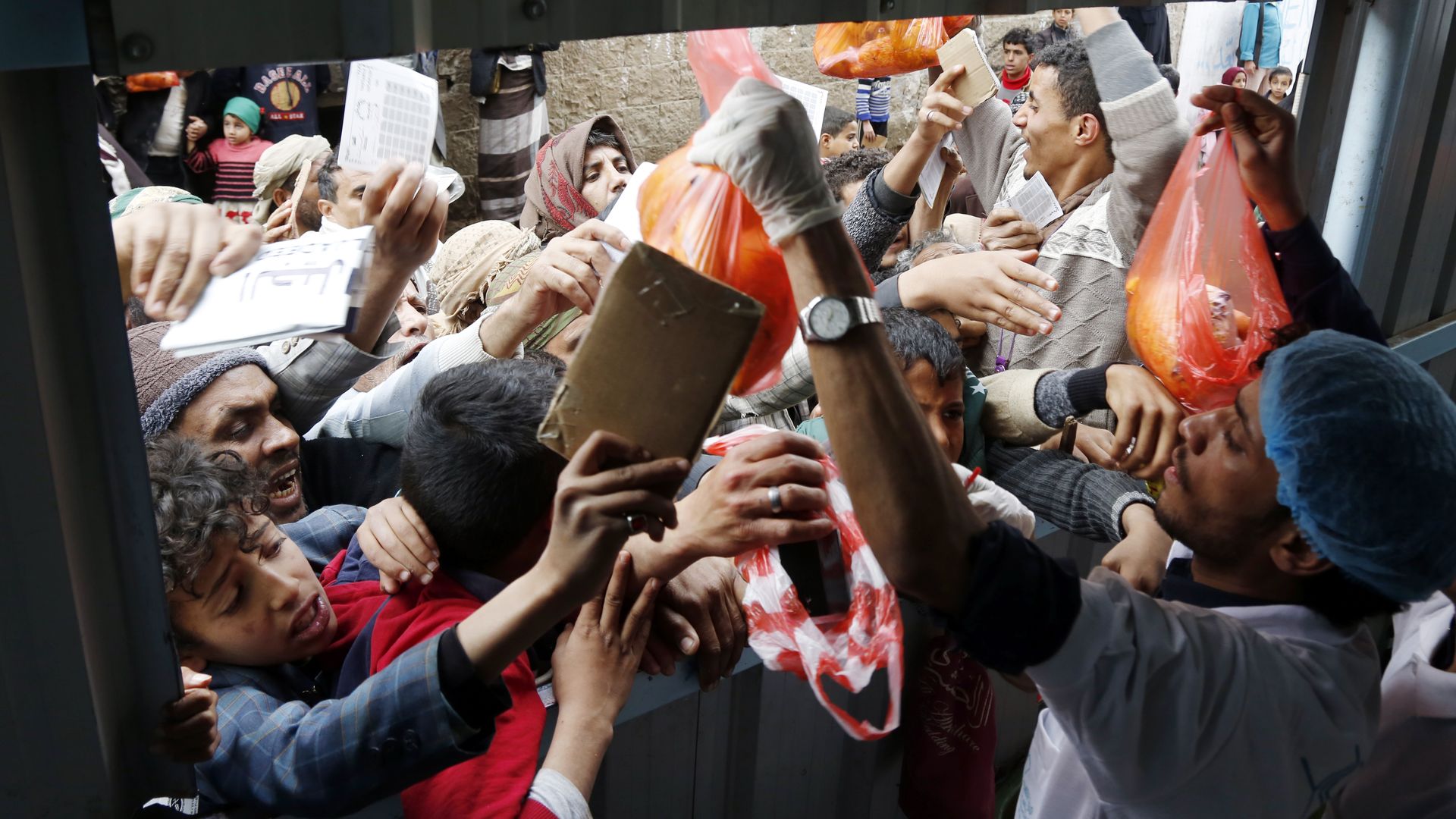 People in in Sana'a, Yemen, receiving meals from a charitable kitchen in December 2022.