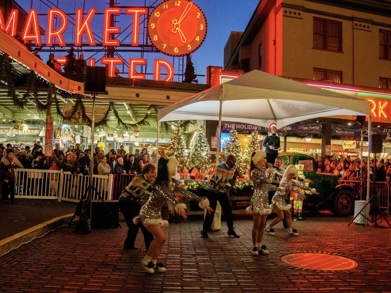Holiday performance and crowd at Pike Place Market’s Magic in the Market celebration
