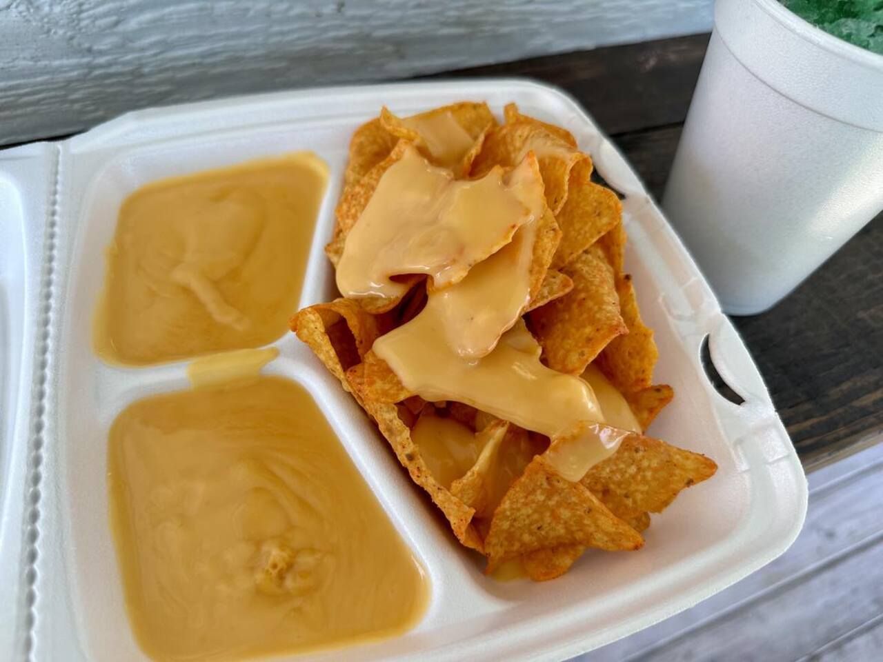 Photo shows a takeout box of nachos