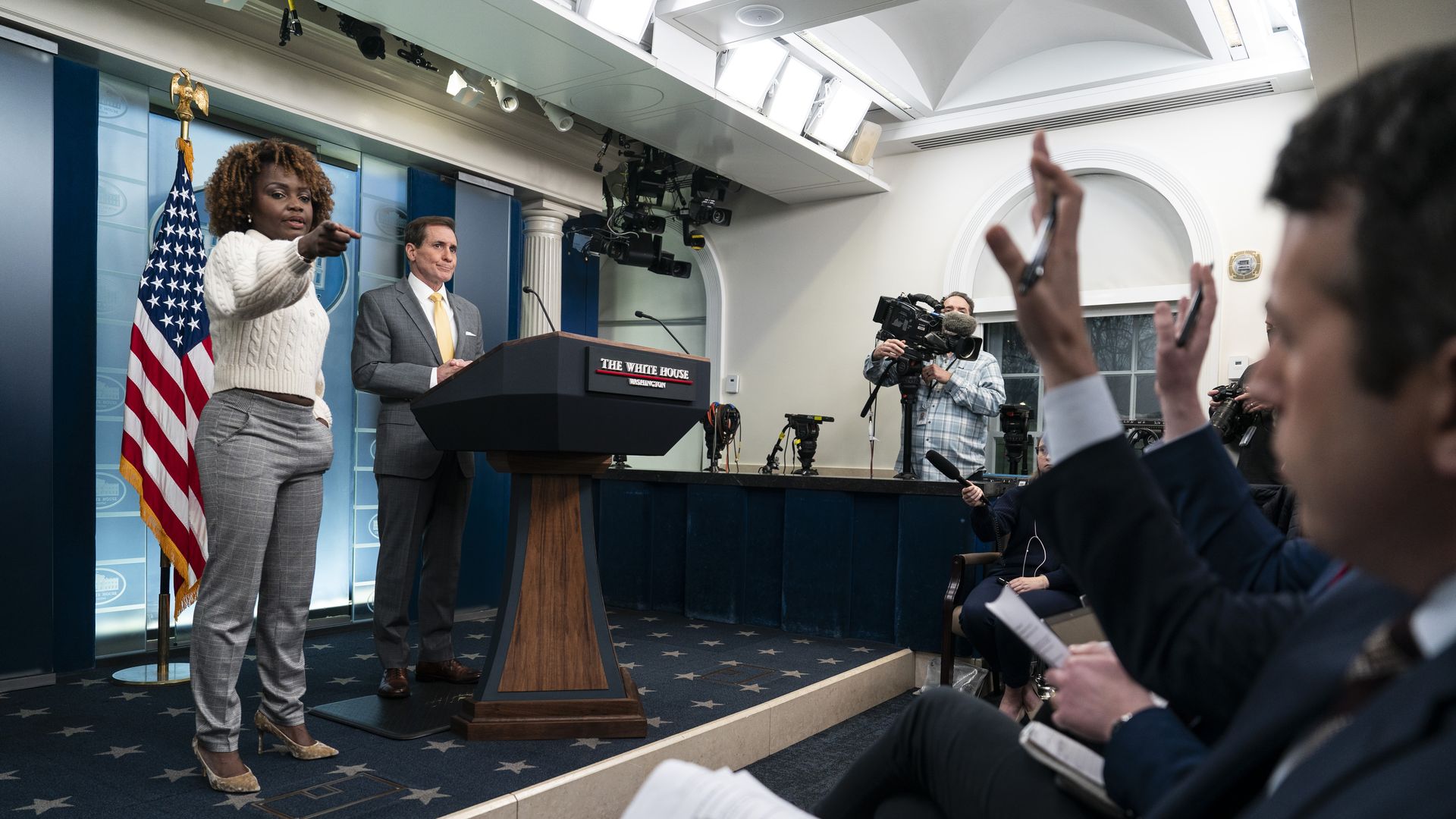 White House Press Secretary Karine Jean-Pierre calls on a reporter with John Kirby at the podium.
