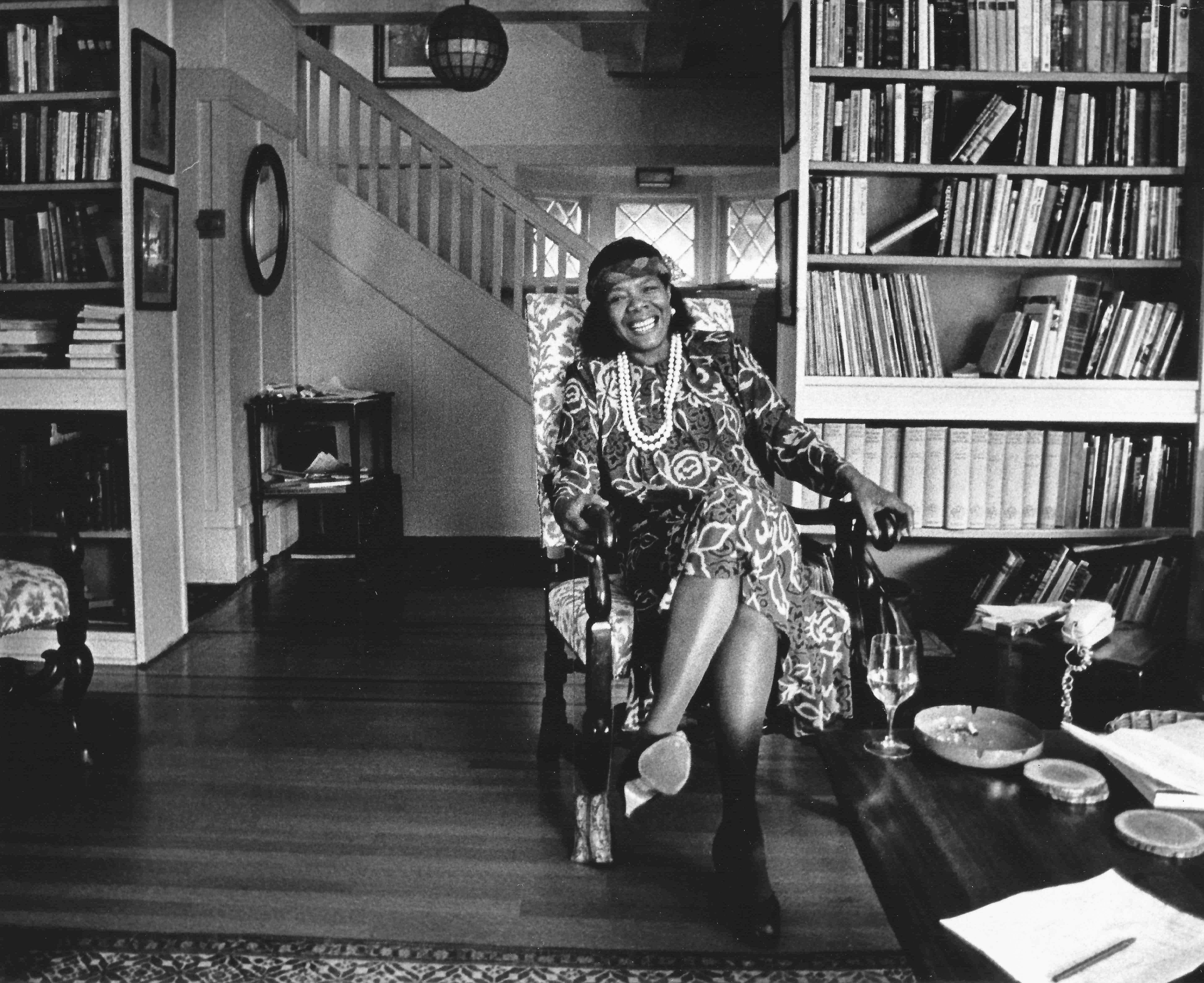 maya angelou sitting in a chair, smiling 