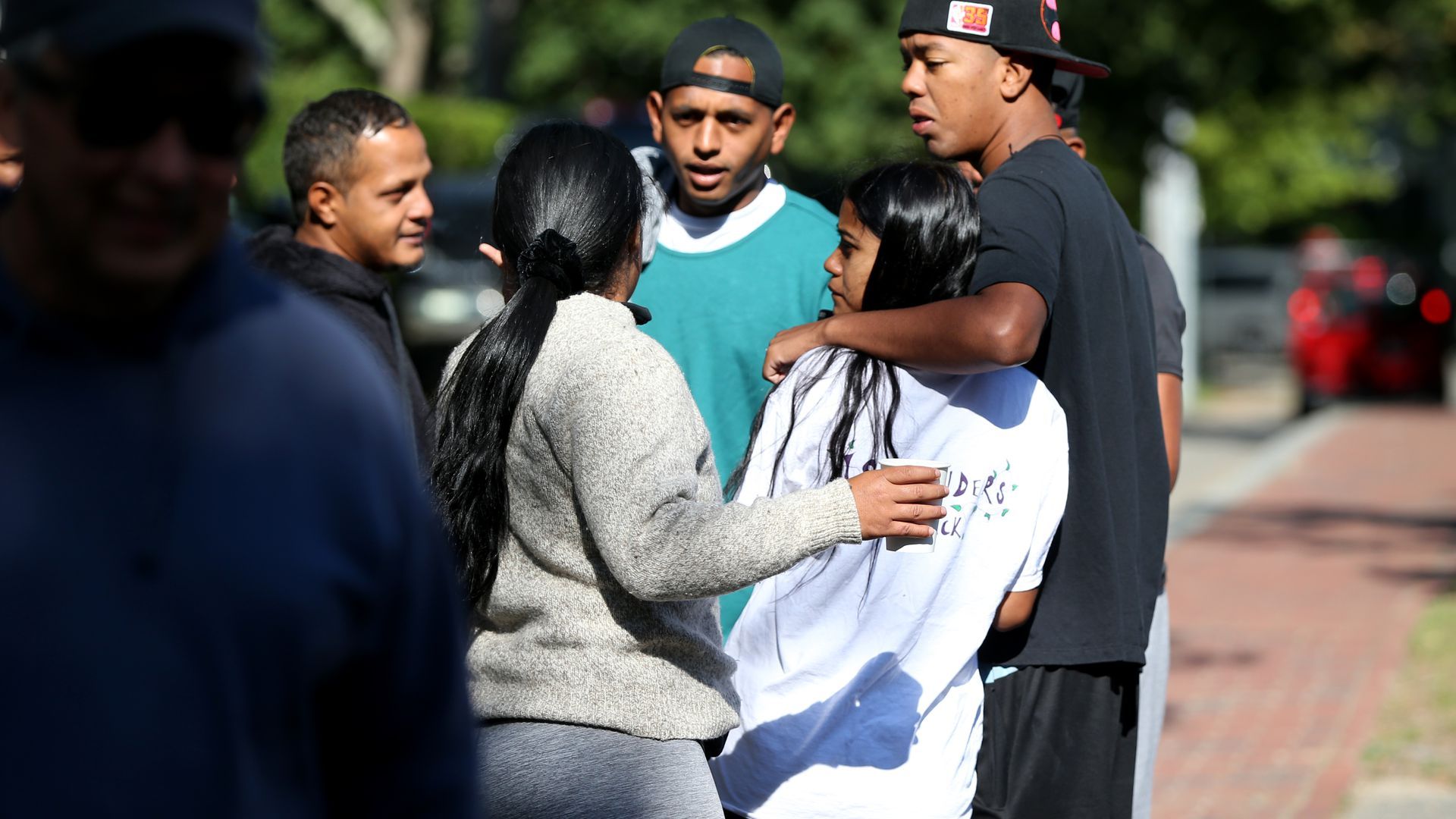 Photo of migrants huddled on the street