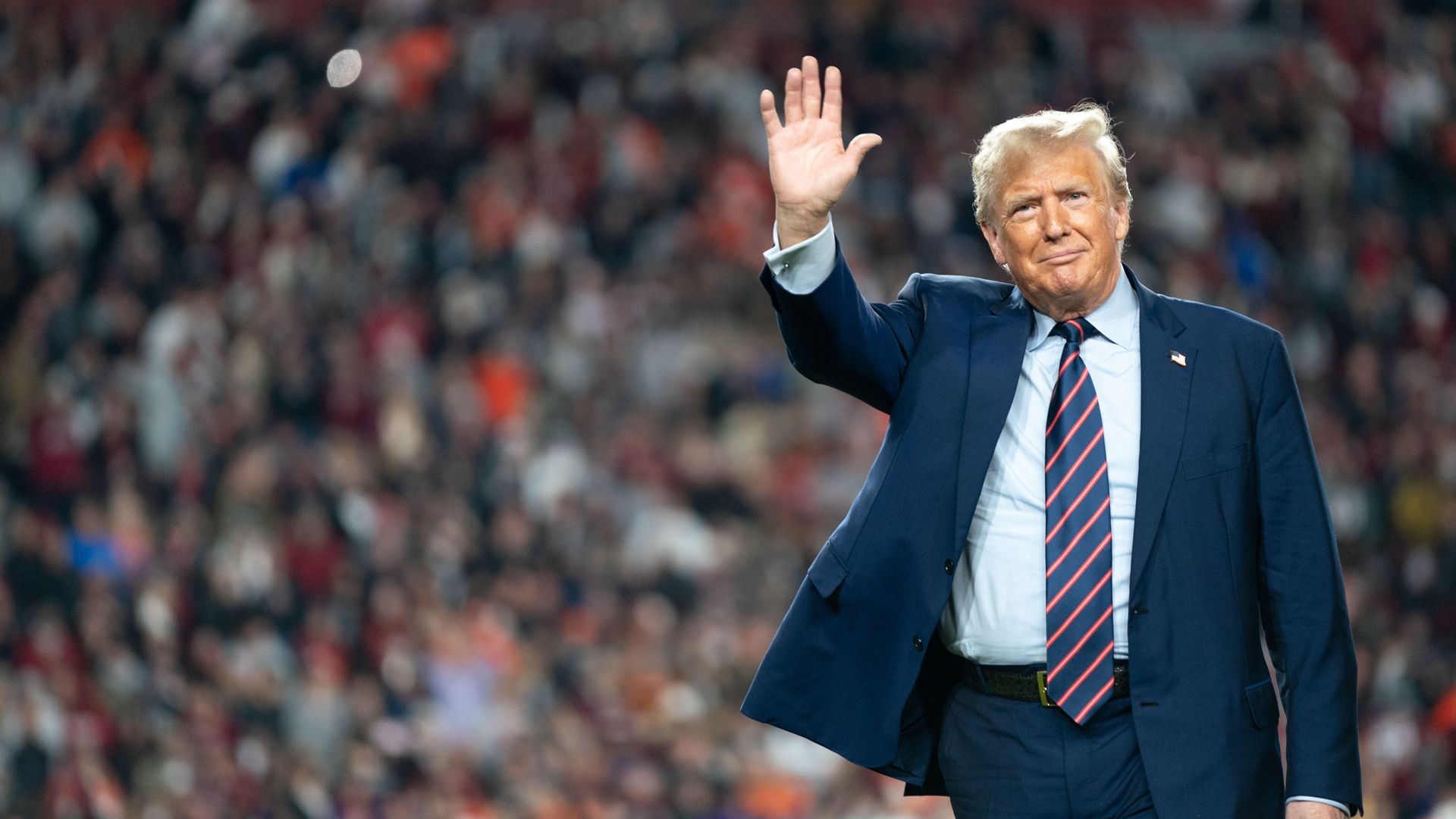 Trump waves while walking