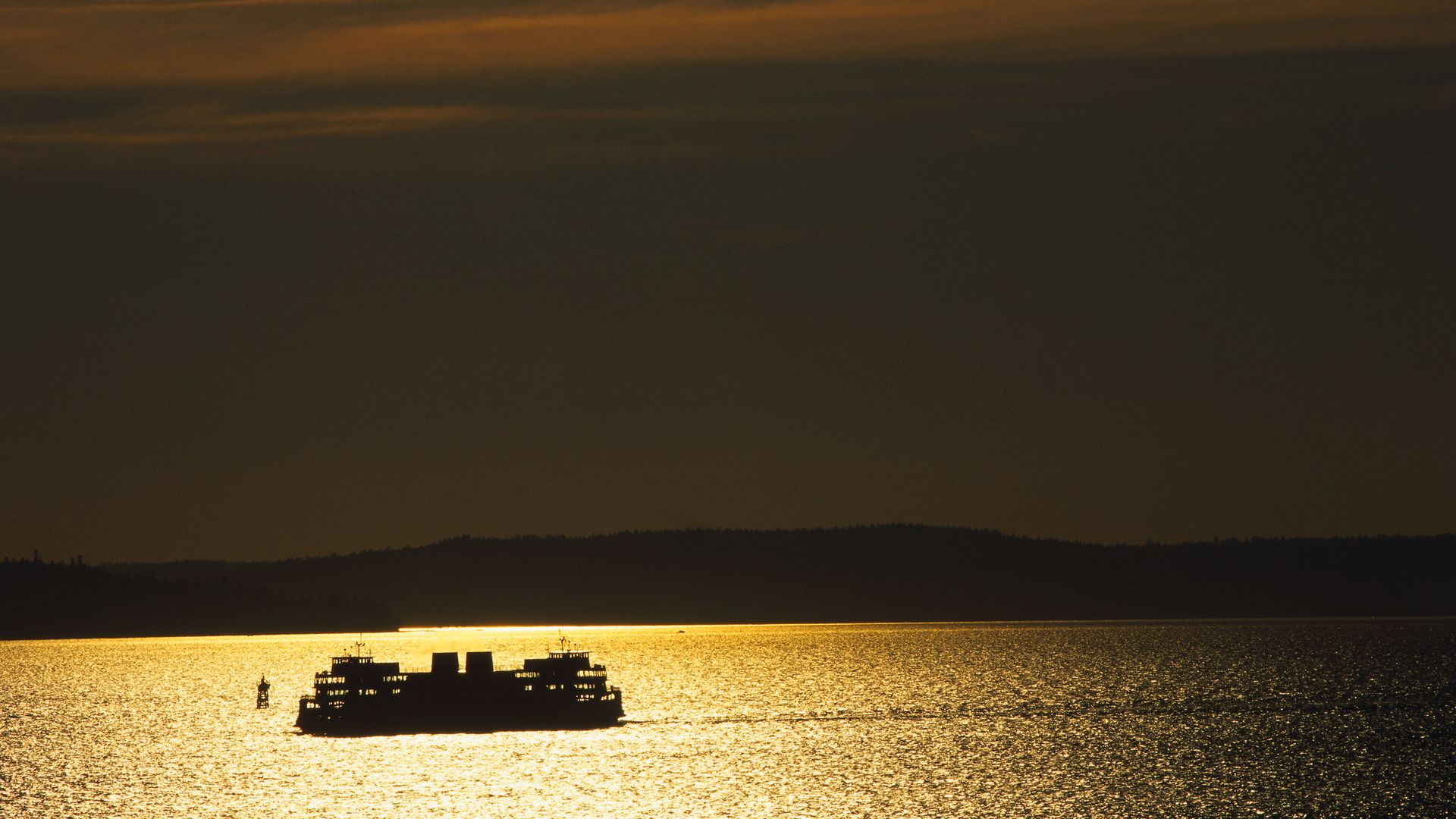 A ferry sails into the sunset in Washington state. 