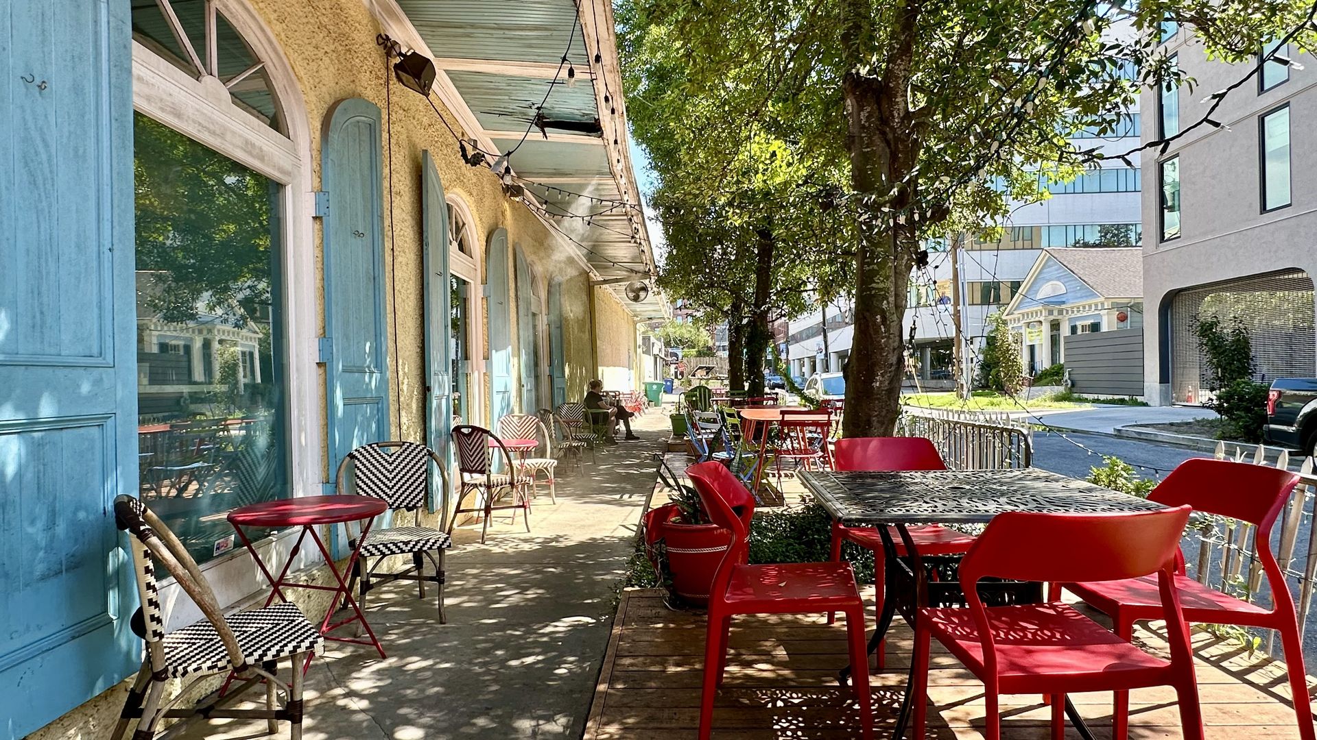 Photo shows tables and chairs outside.