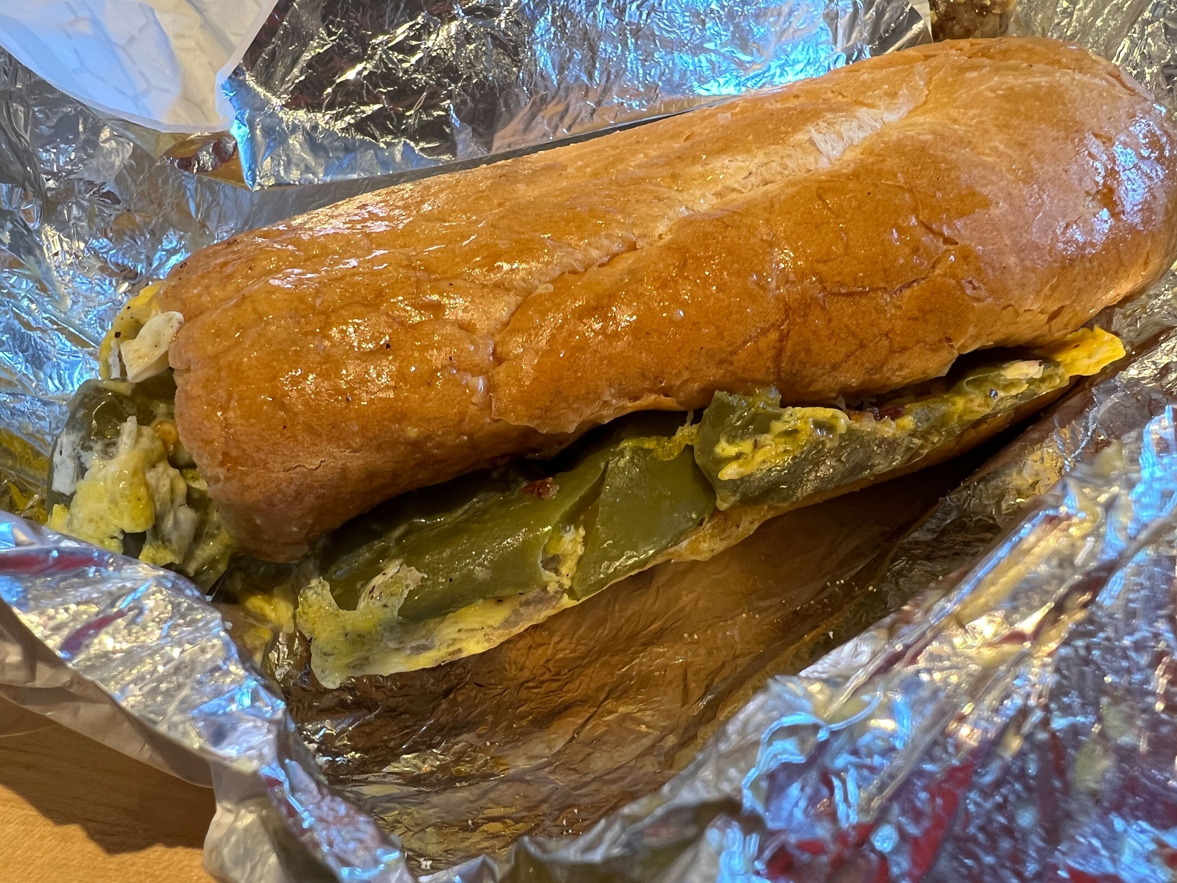 Greasy sandwich on a french roll on foil 