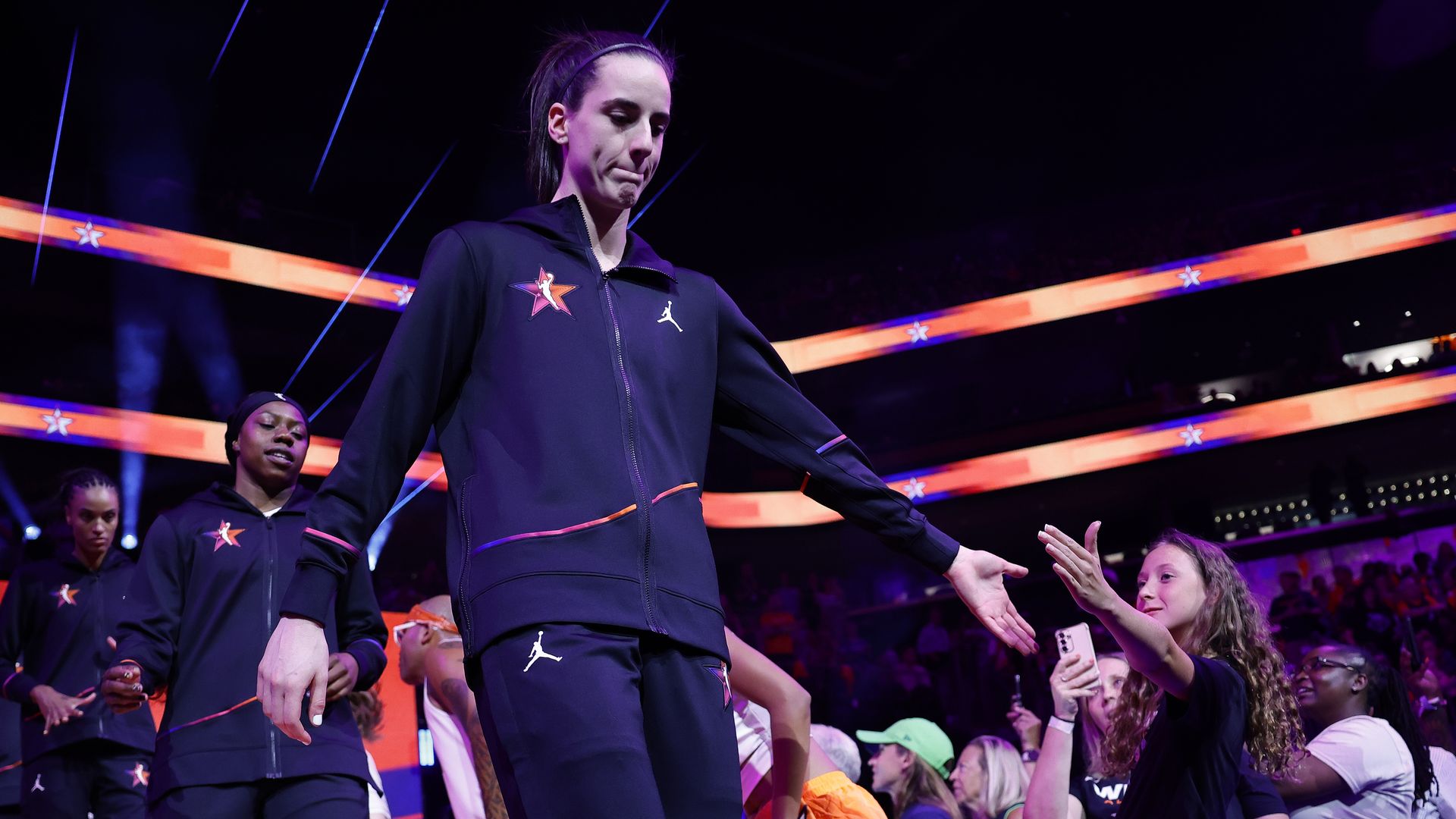A basketball player in navy warmups