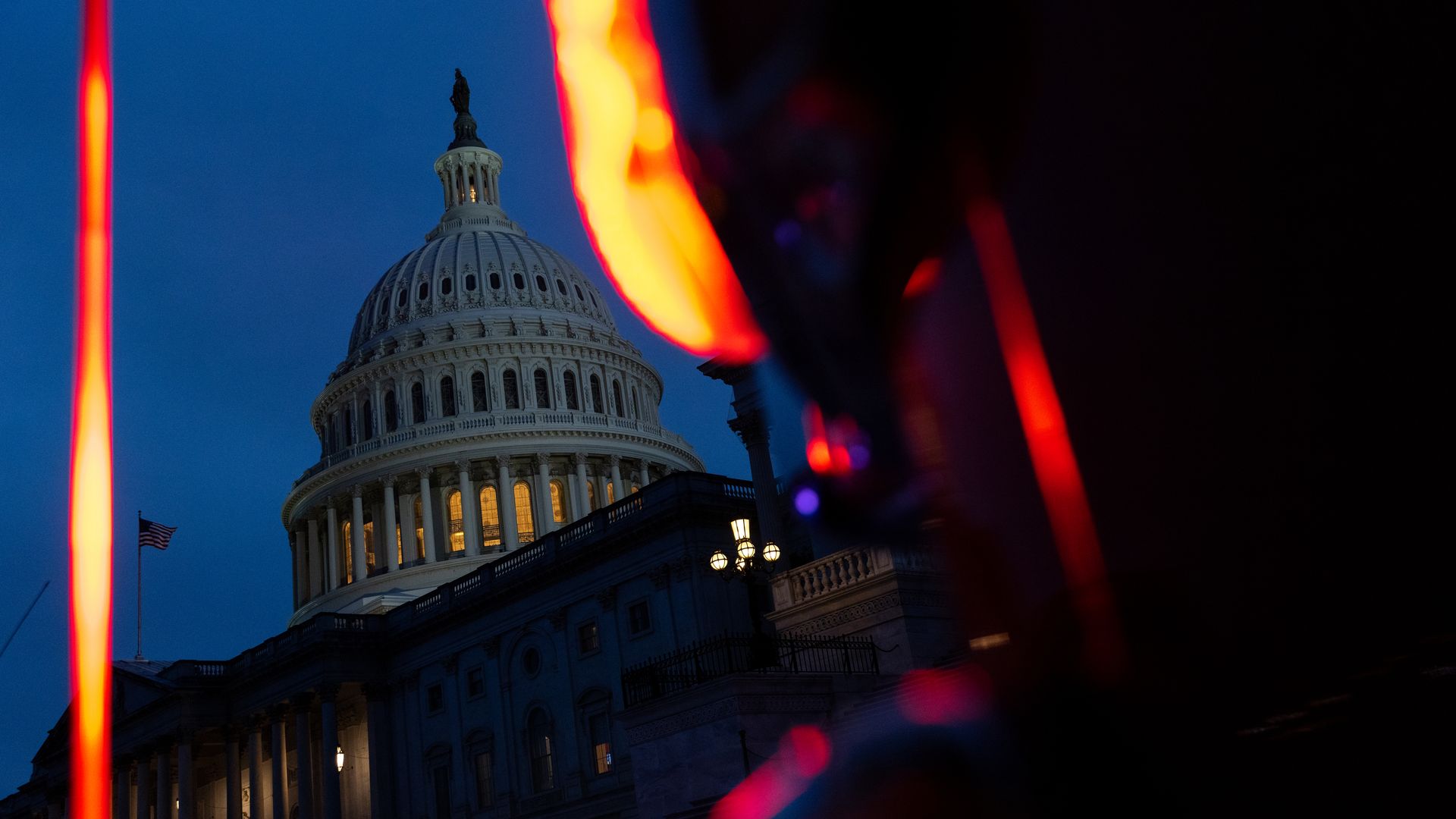 United States Capitol at night with a motorcycle's headline in the foreground.