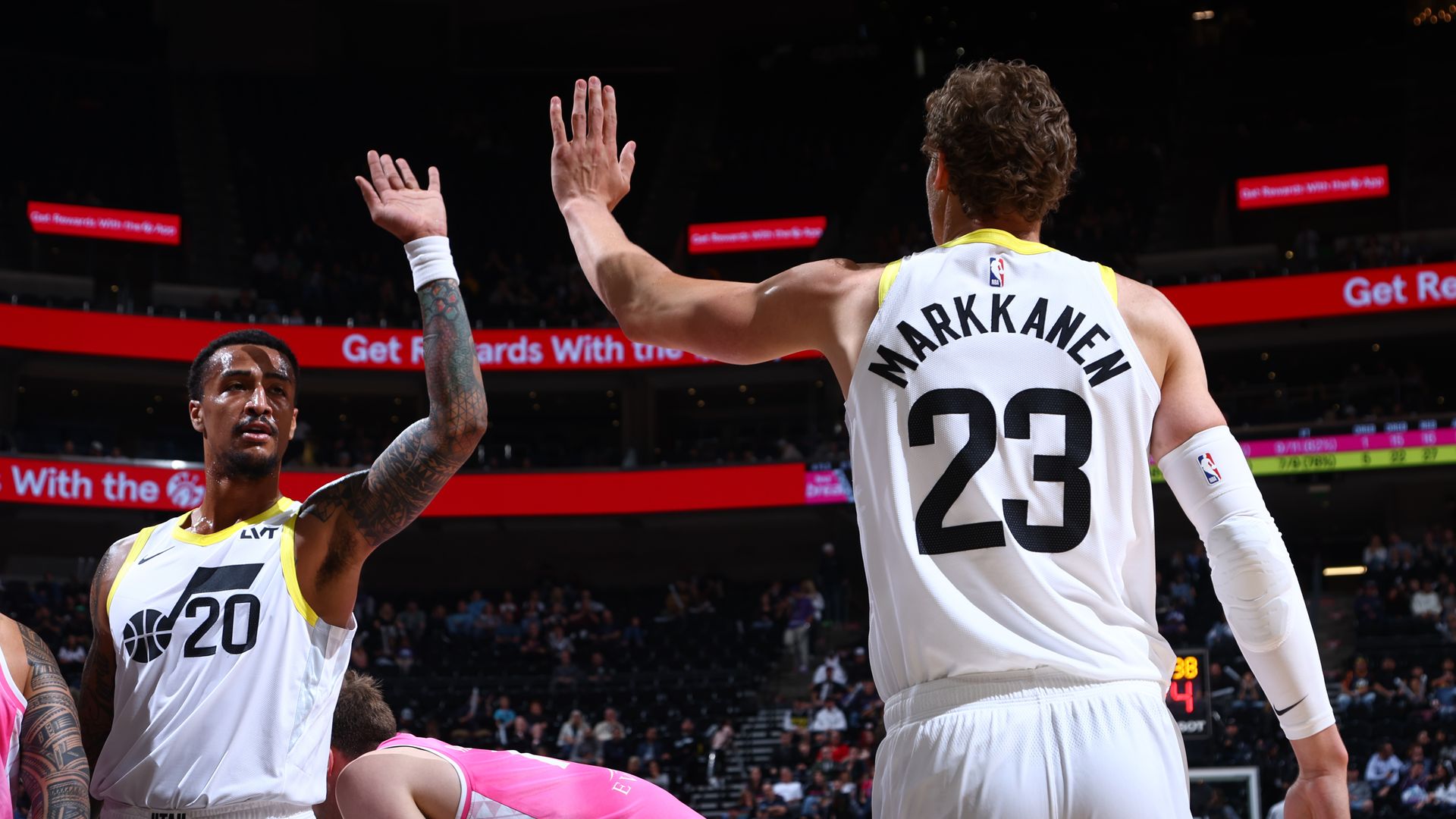 Two basketball players high five each other