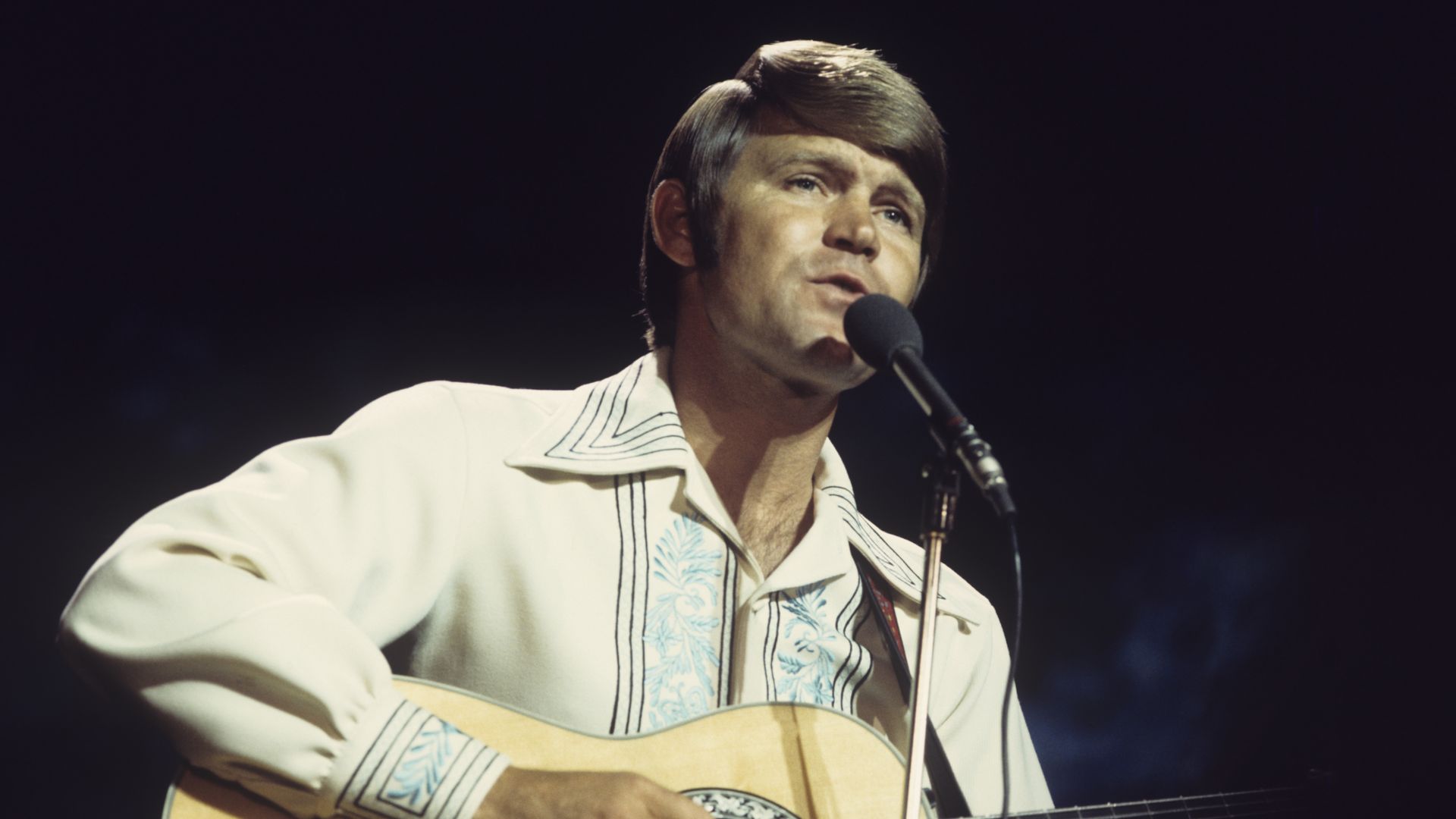 American singer Glen Campbell performs on a television show circa 1974.