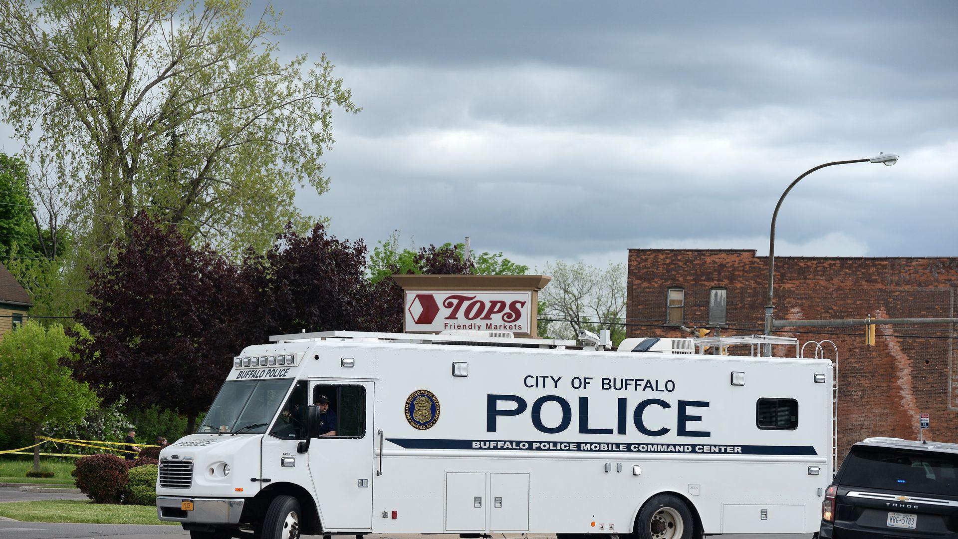 A police mobile command center sits in front of the Tops market in Buffalo, N.Y., that was the site of a mass shooting.