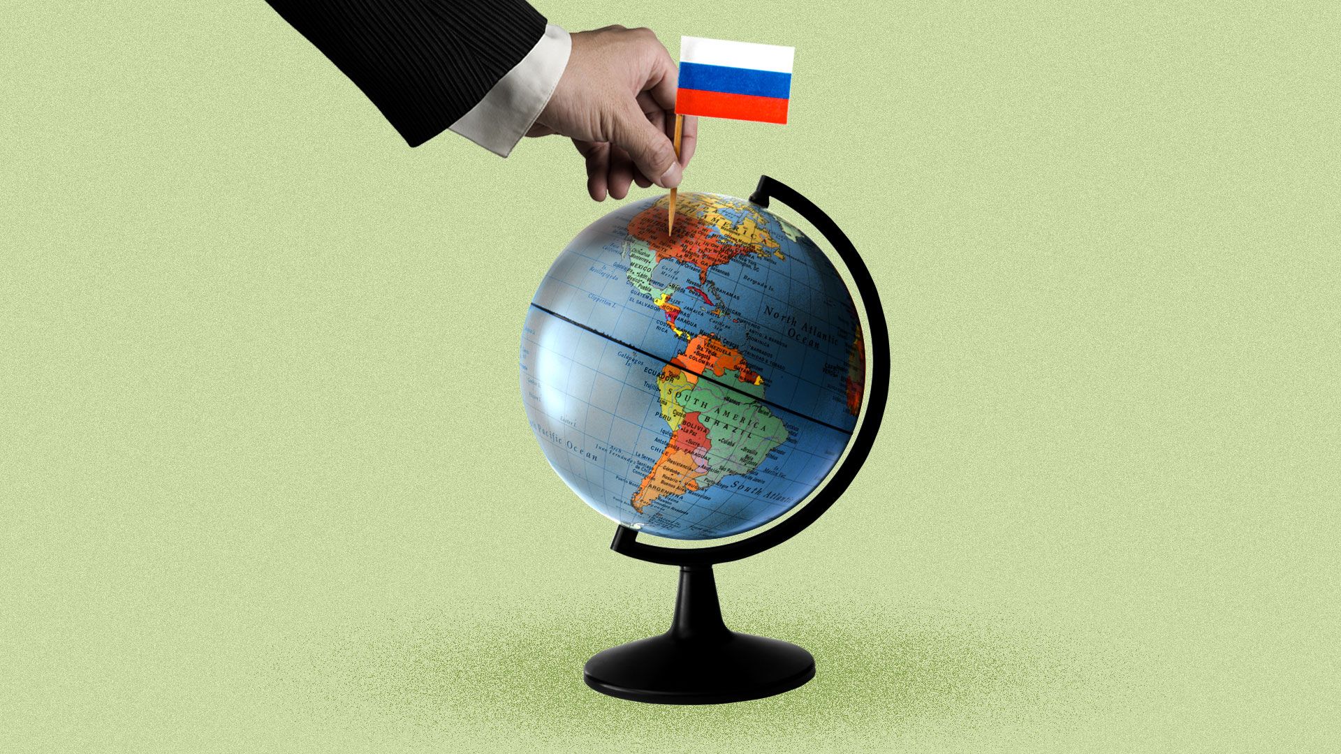 A hand planting a Russian flag on a globe