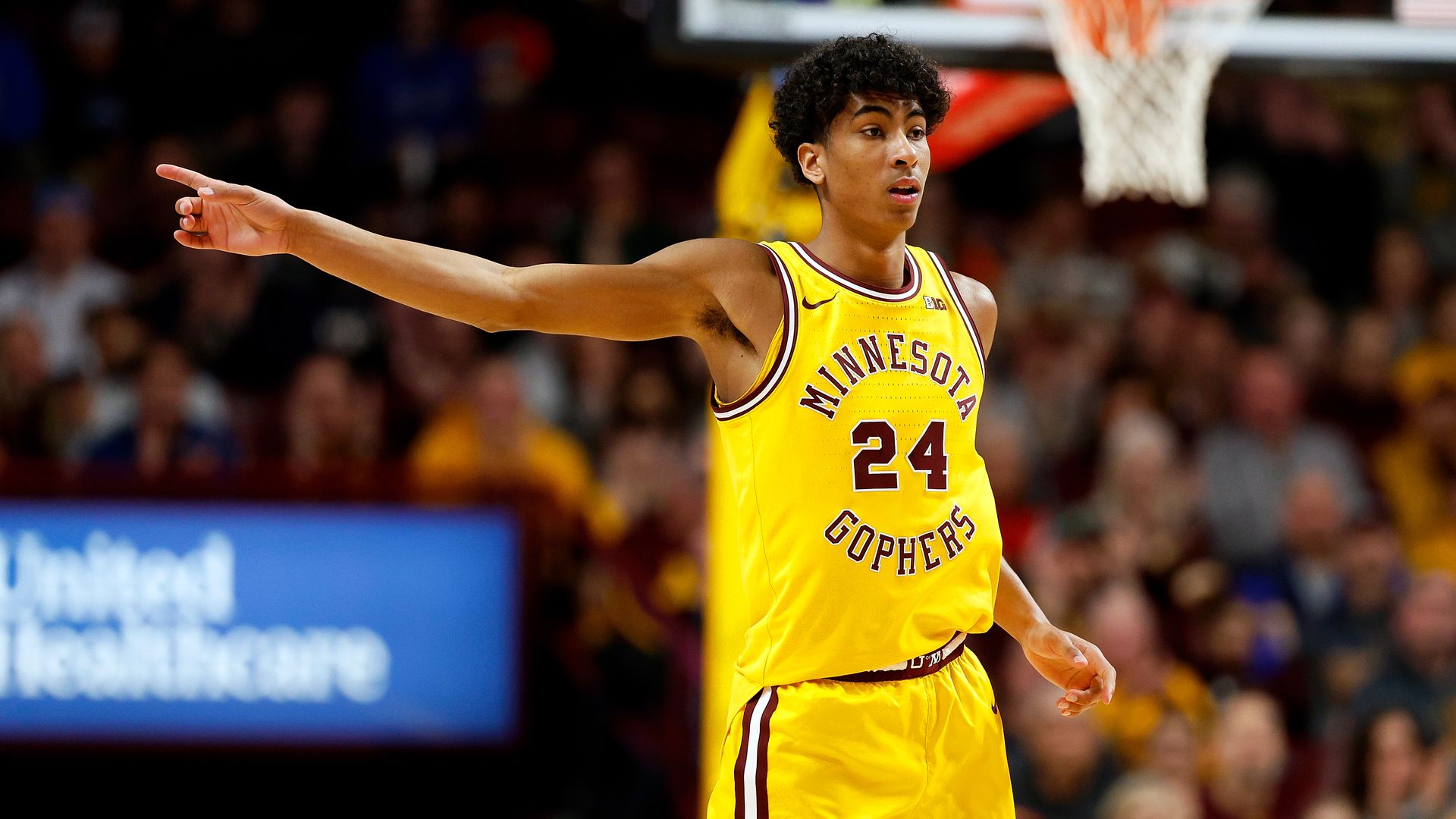 Cam Christie points as he stands on the court 