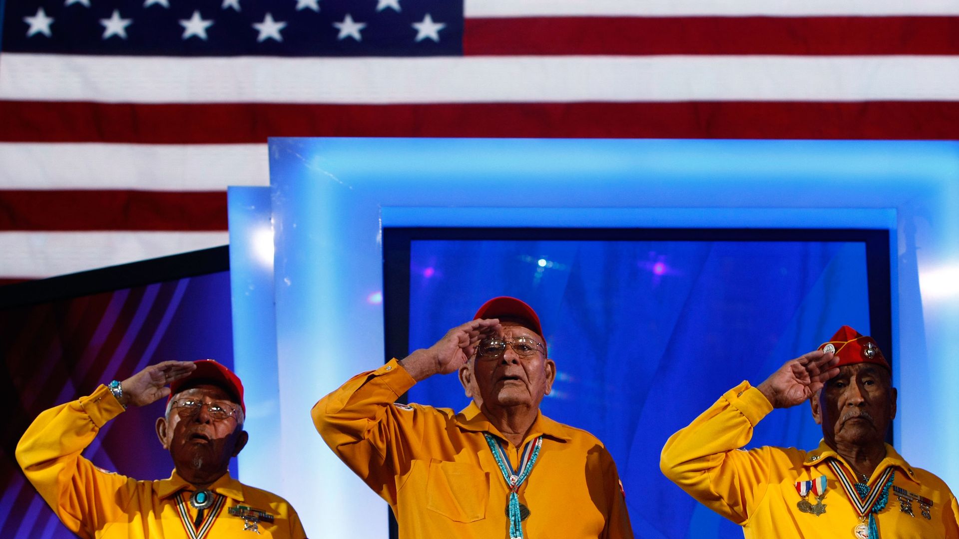 Members of the Navajo Code Talkers Association salute during the Presentation of Colors during day one of the Democratic National Convention in 2008.
