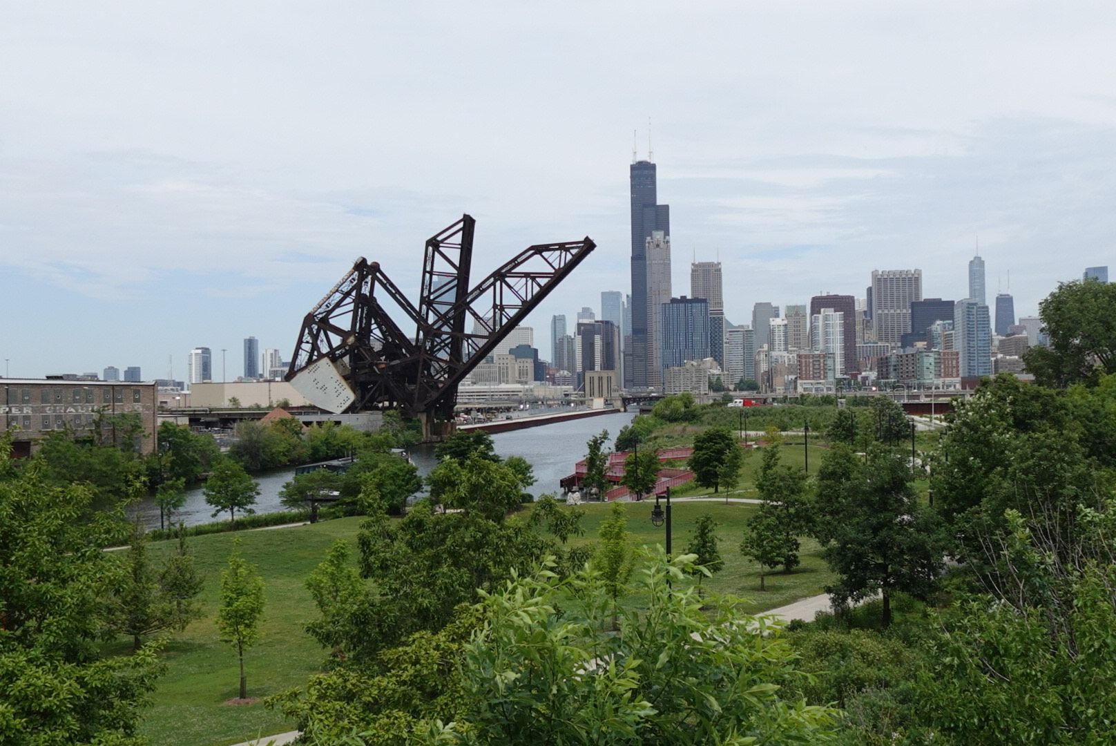 Photo of a skyline with trees and a river in front of it. 
