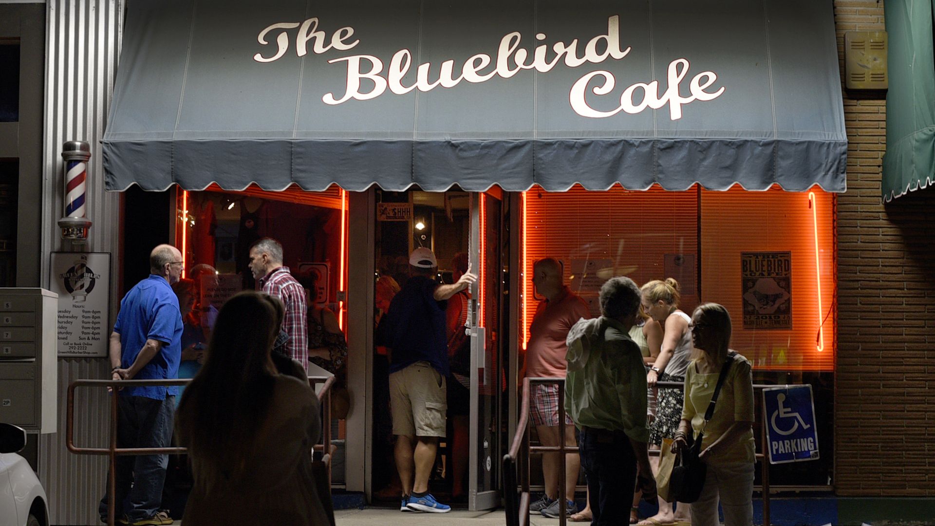 Exterior shot showing a line outside the bluebird cafe
