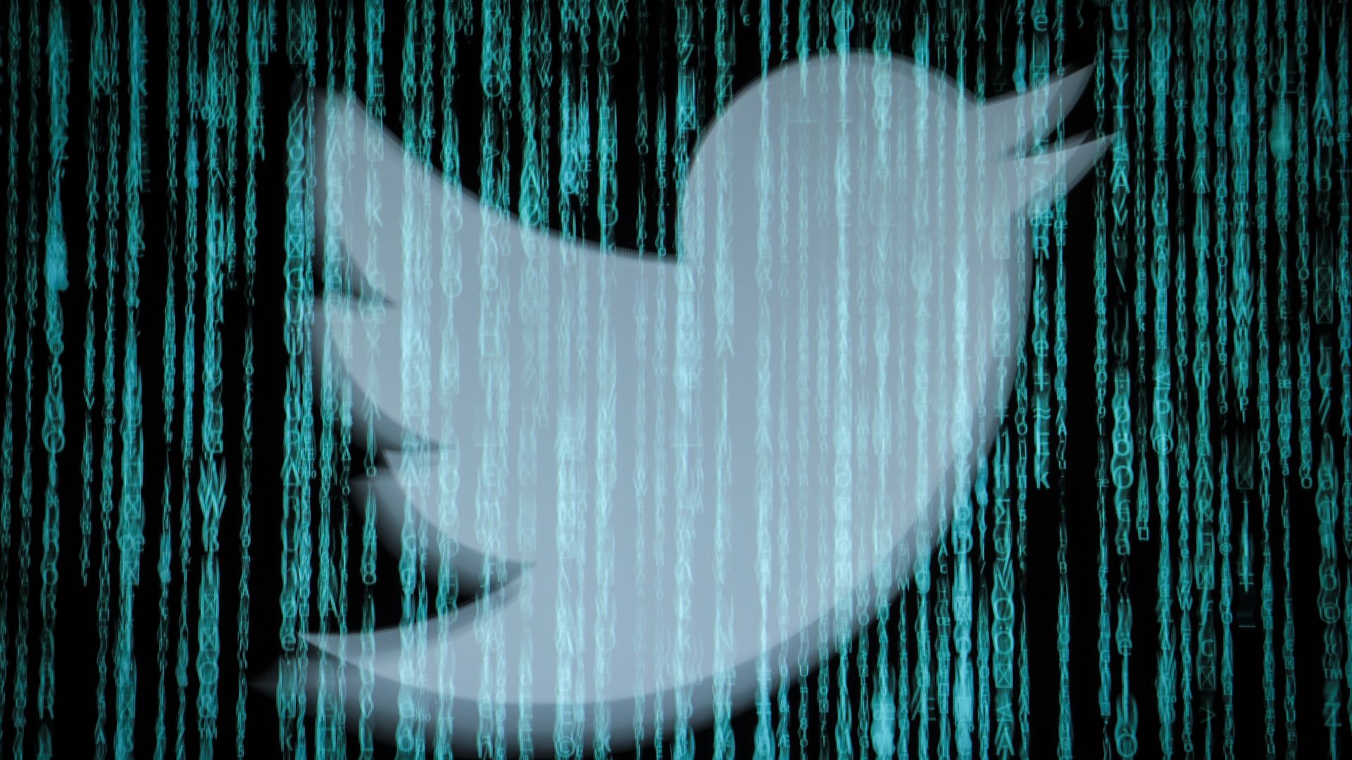 Twitter logo behind computer code