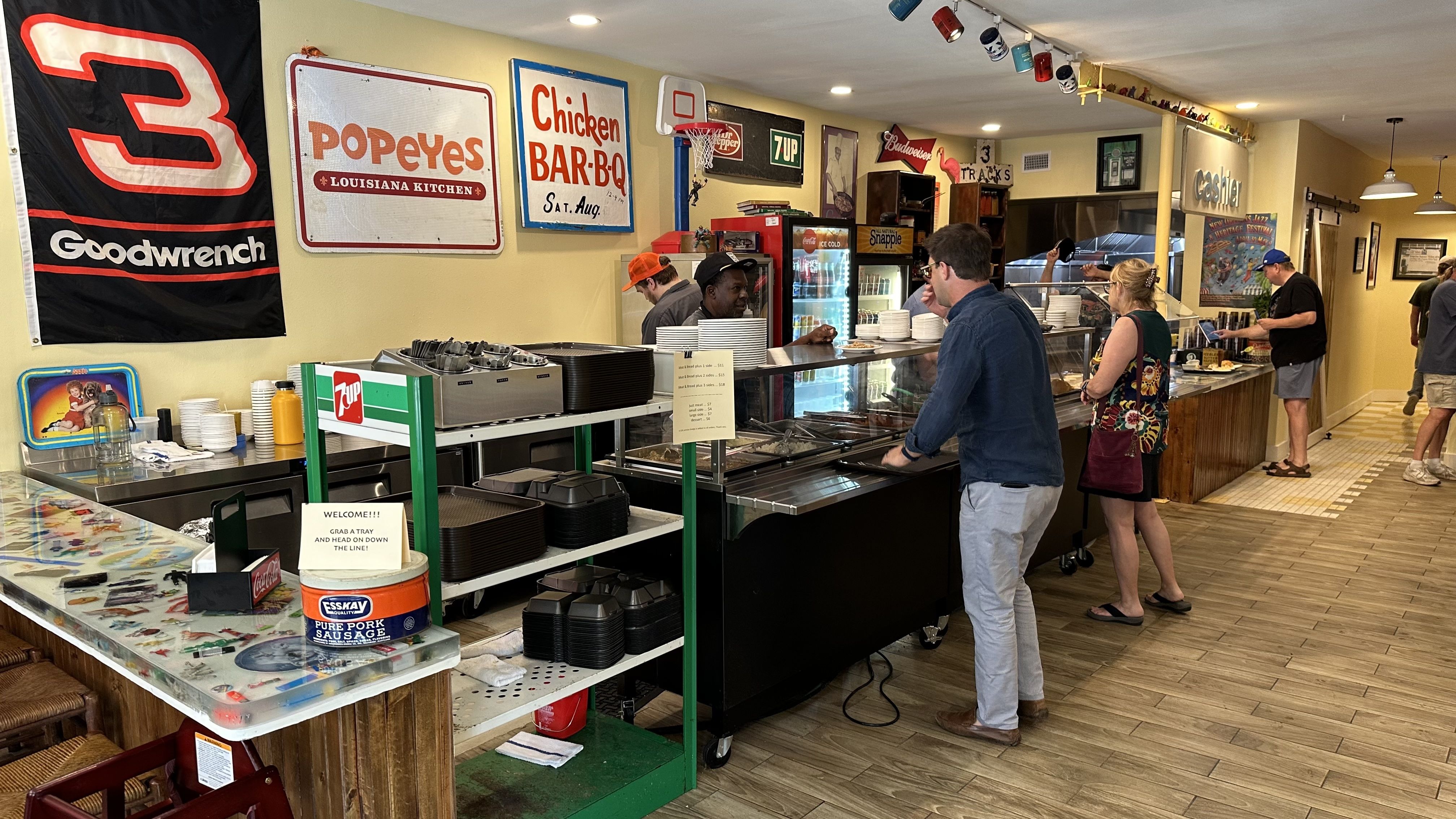 Two people stand ready to order at the cafeteria counter inside Hot Stuff.