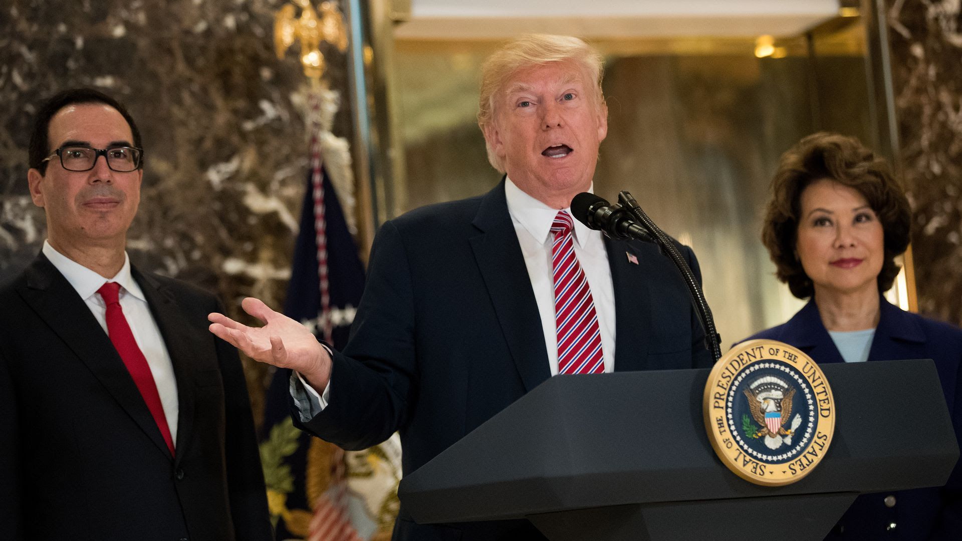 President Trump speaks at a podium.