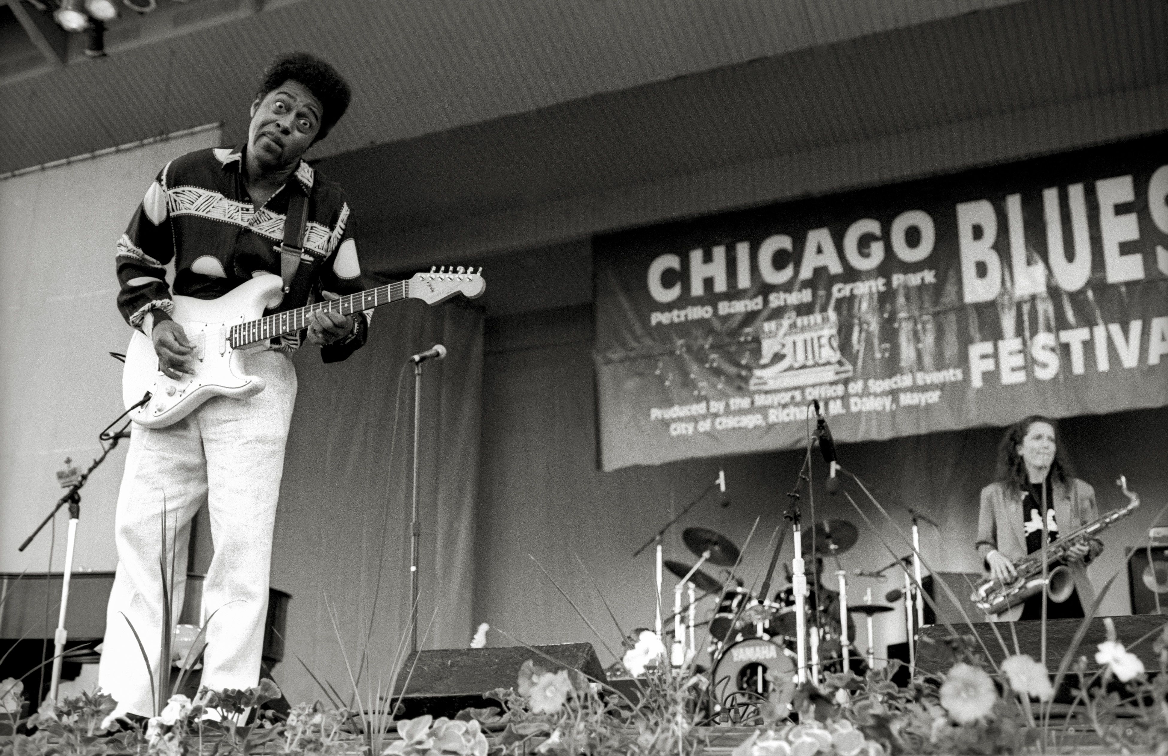 Photo of a man playing guitar on stage 