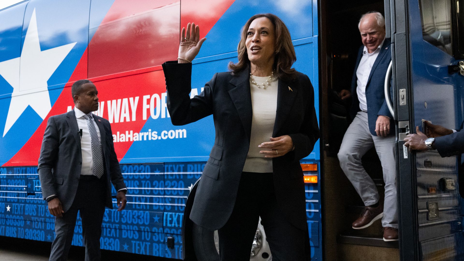 Vice President Harris and her running mate, Minnesota Gov. Tim Walz, disembark from their campaign bus in Savannah, Ga.