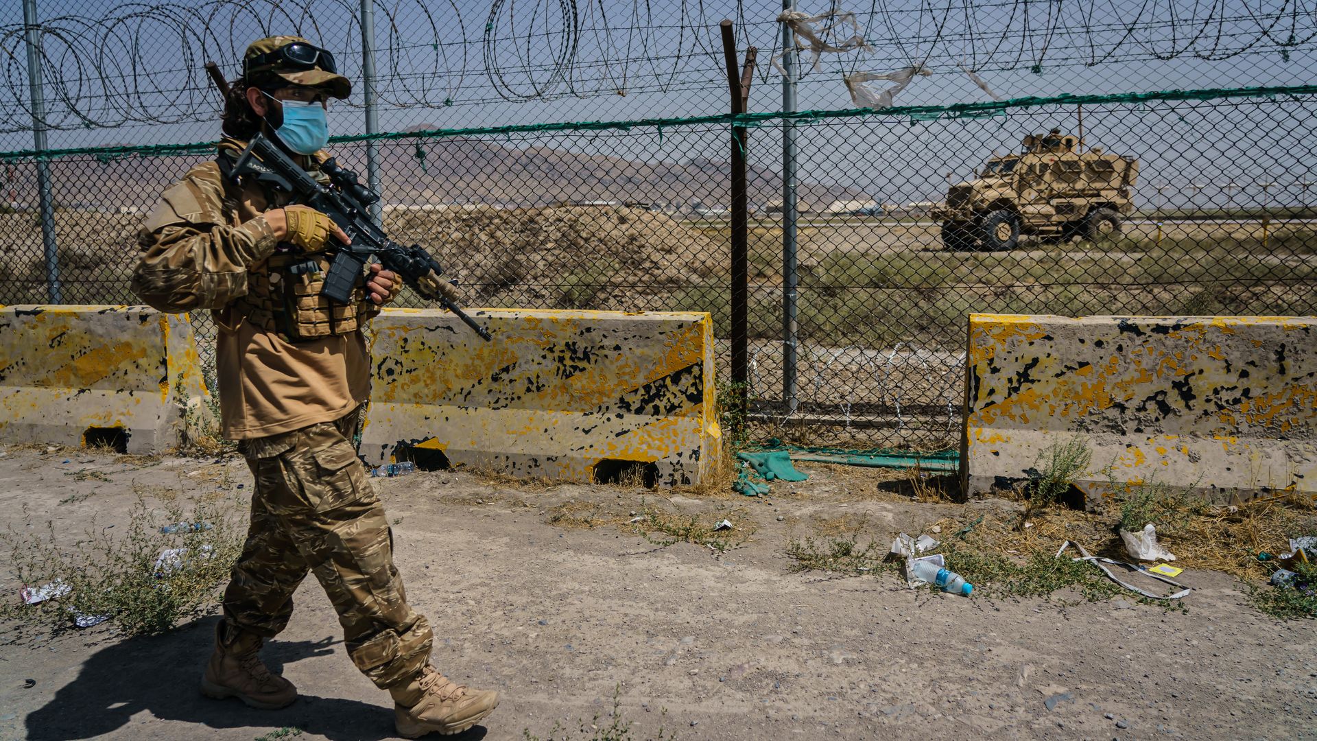 Taliban fighters secure the outer perimeter, in plain sight of the American forces that control the Hamid Karzai International Airport in Kabul, Afghanistan