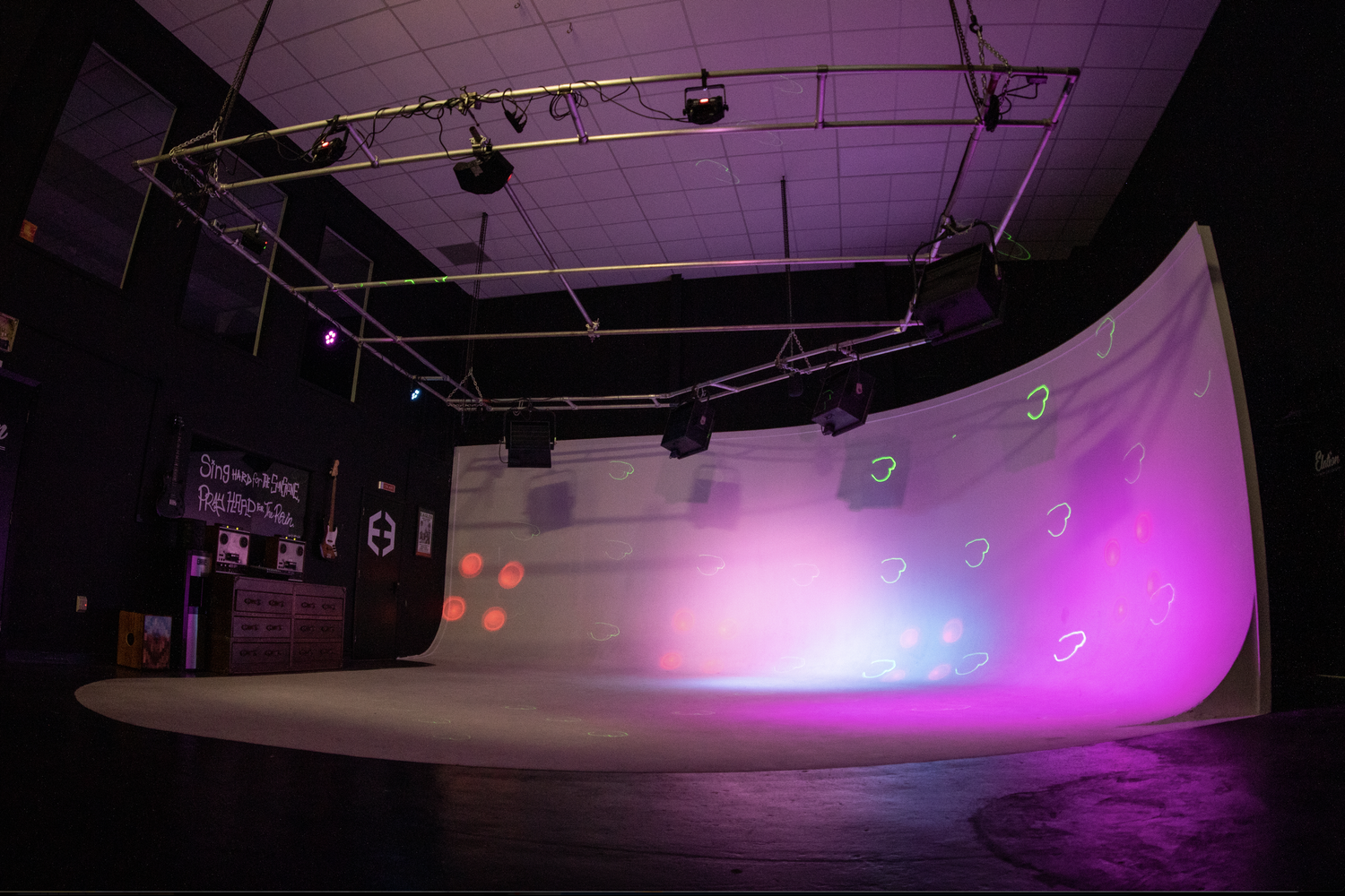 Photo shows a cyc wall that's lit up pink.