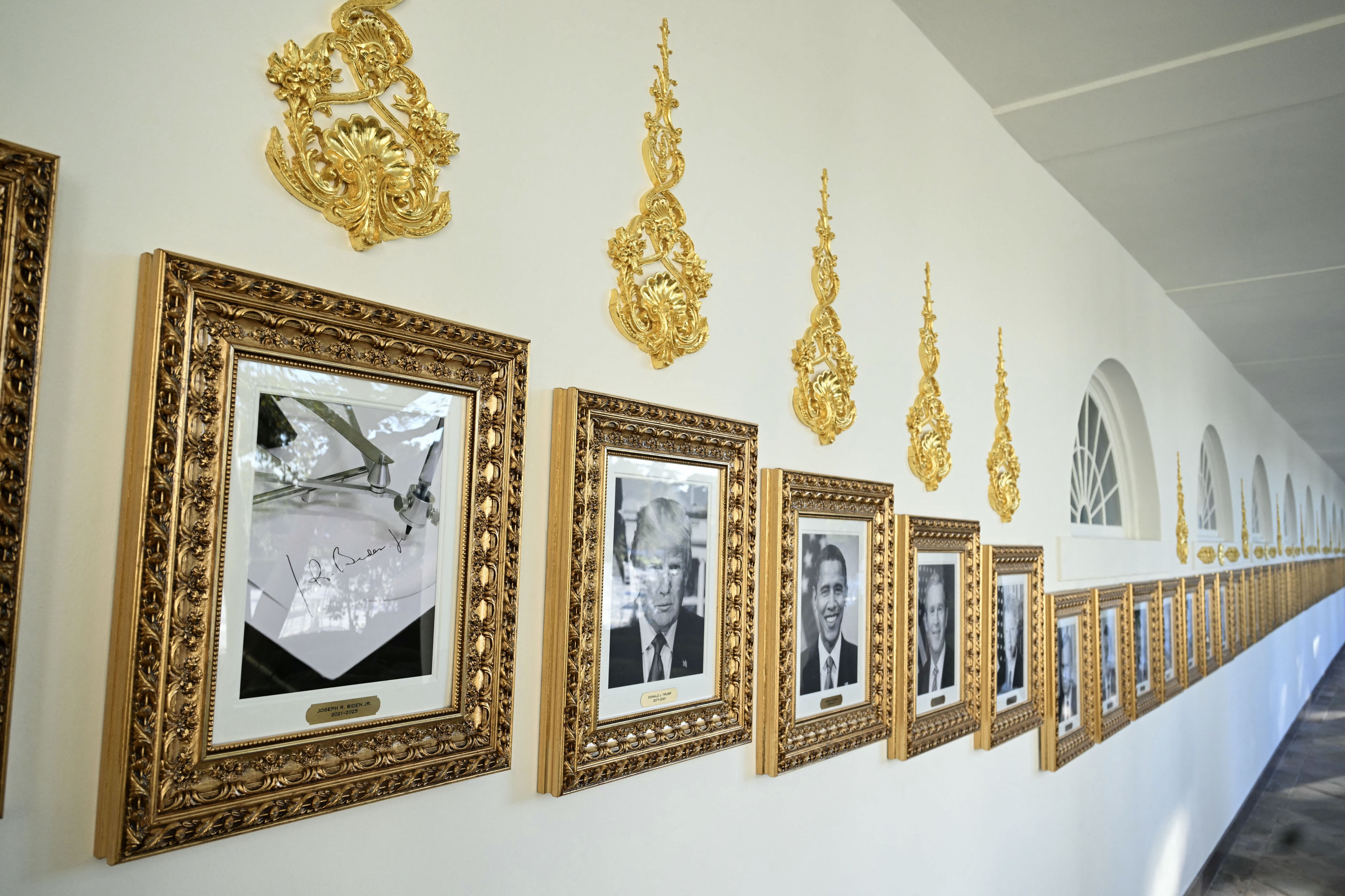Portraits of presidents hung in golden frames line the West Colonnade.