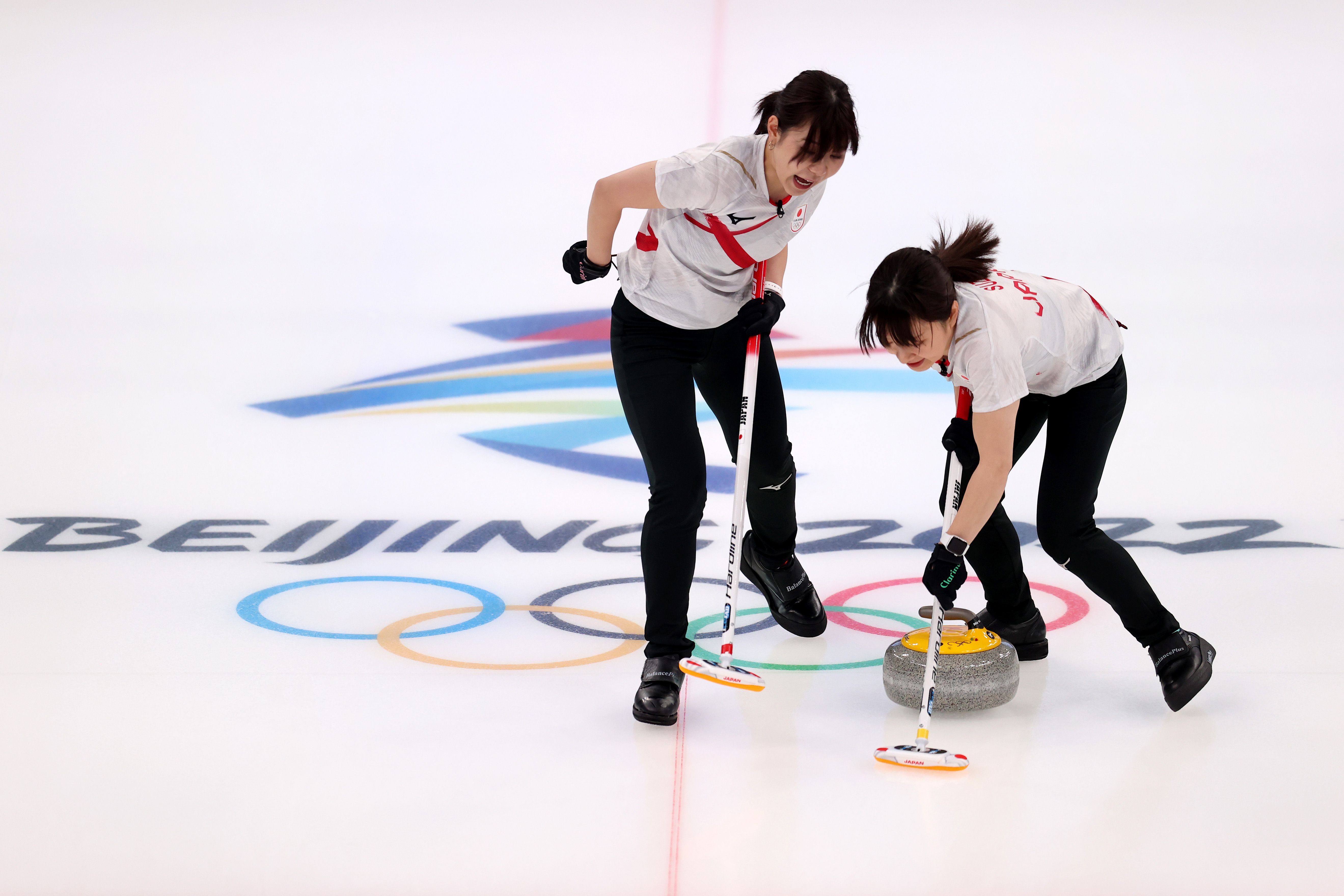  Chinami Yoshida (L) and Yumi Suzuki of Team Japan compete against Team Canada during the Women's Round Robin Curling Session in the Winter Olympic Games in Beijing, China, Feb. 11