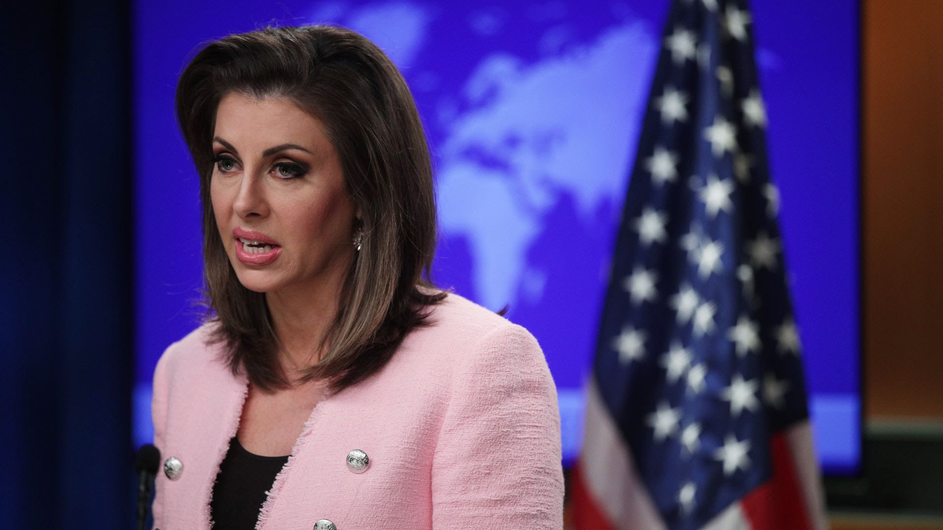 Morgan Ortagus speaks in front of an American flag