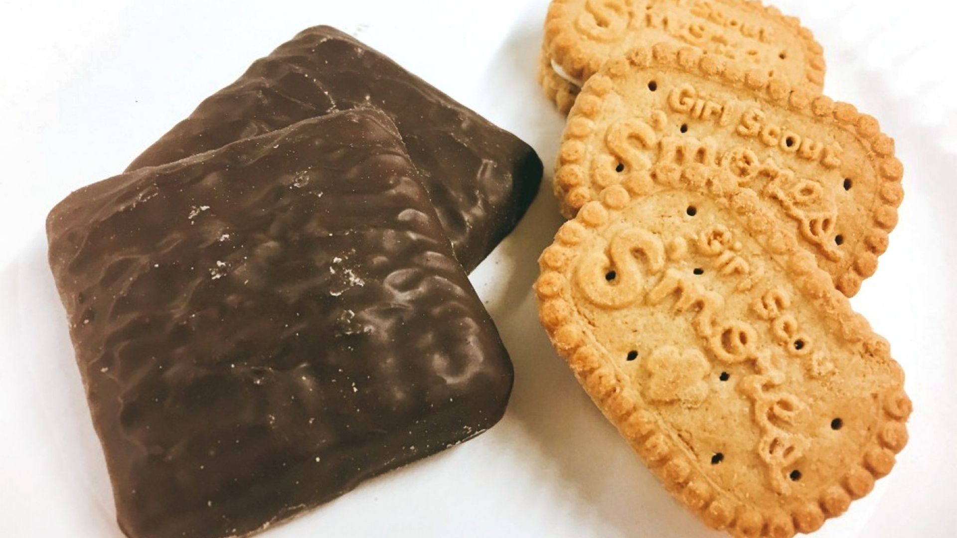 A handful of thin mint and smore girl scout cookies.