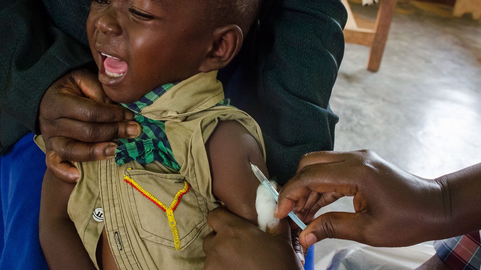 Photo of a boy being immunized against polio in Uganda