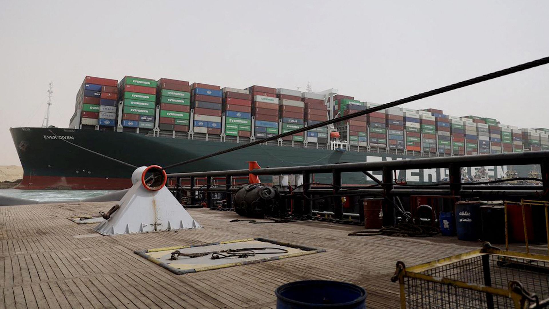 An Egyptian tug uses a rope to try to free the Ever Given (owned by Evergreen).