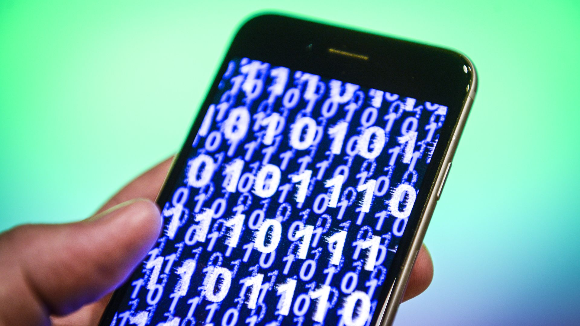 A phone with 0s and 1s in blue before a green background.