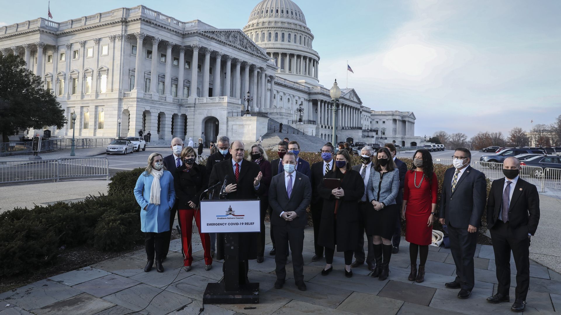 Members of the Problem Solvers Caucus are seen speaking outside the U.S. Capitol.