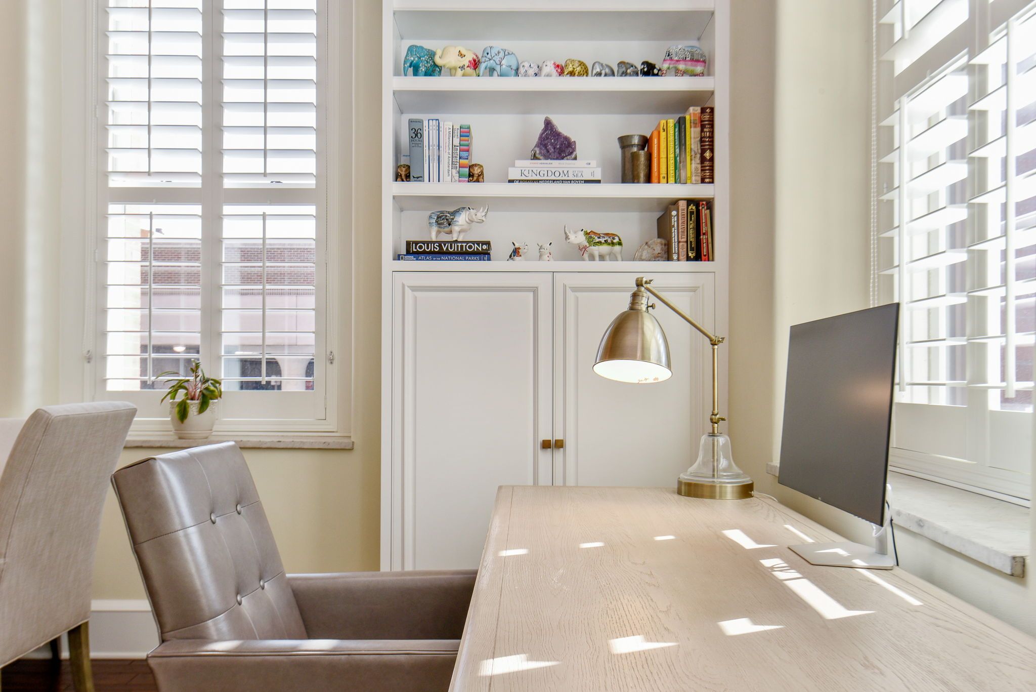 A photo of a desk with a chair and a computer.