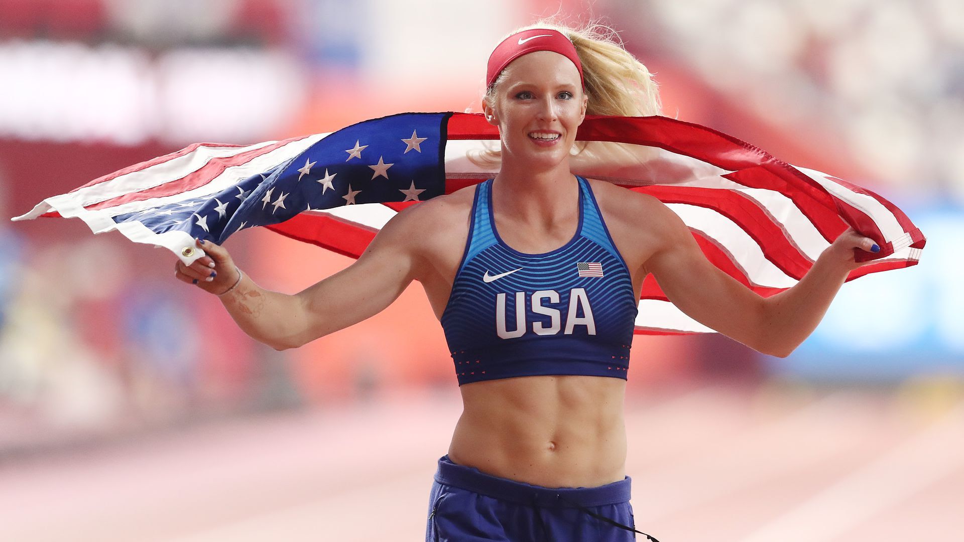 Olympian Sandi Morris running with the American Flag